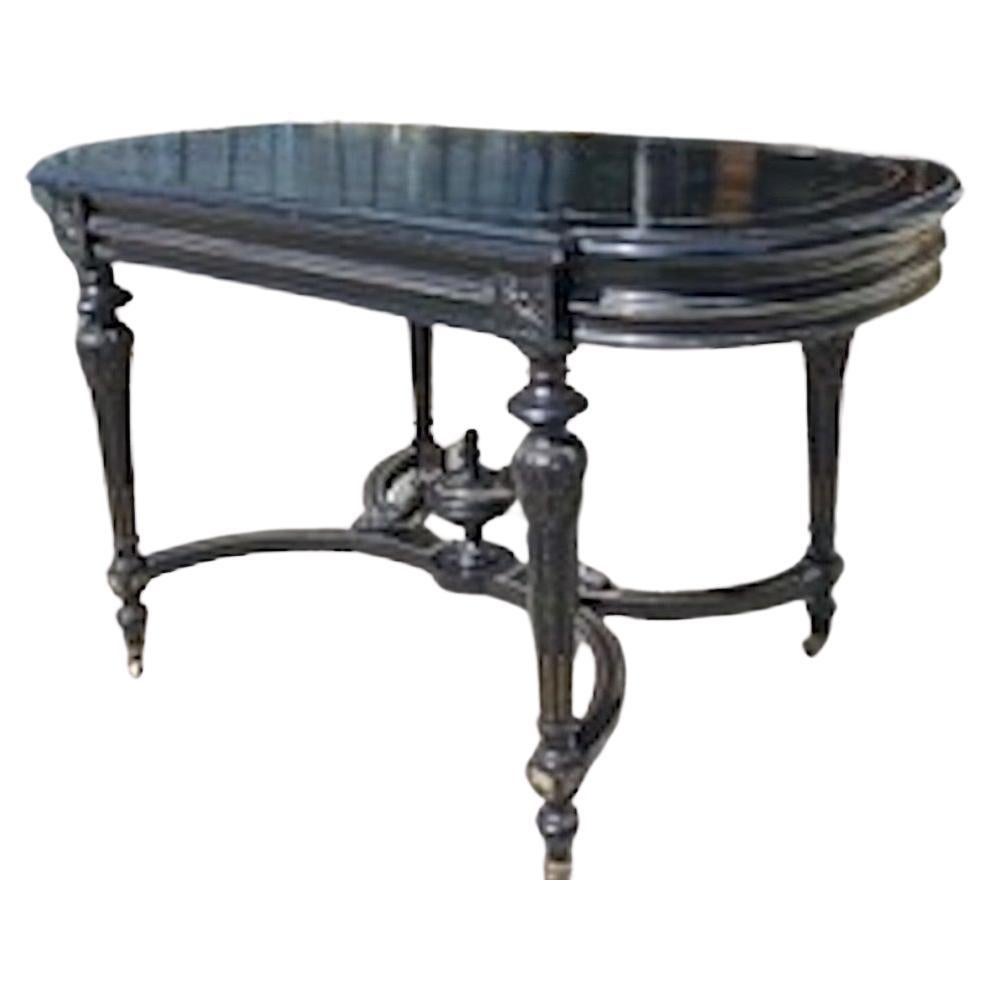 This is a beautiful example of a French Napoleon III 19th Century entry or serving table. It is made of Ebonized walnut with a brass inlay on the shaped carved top and around all sides. It rests on four castors.