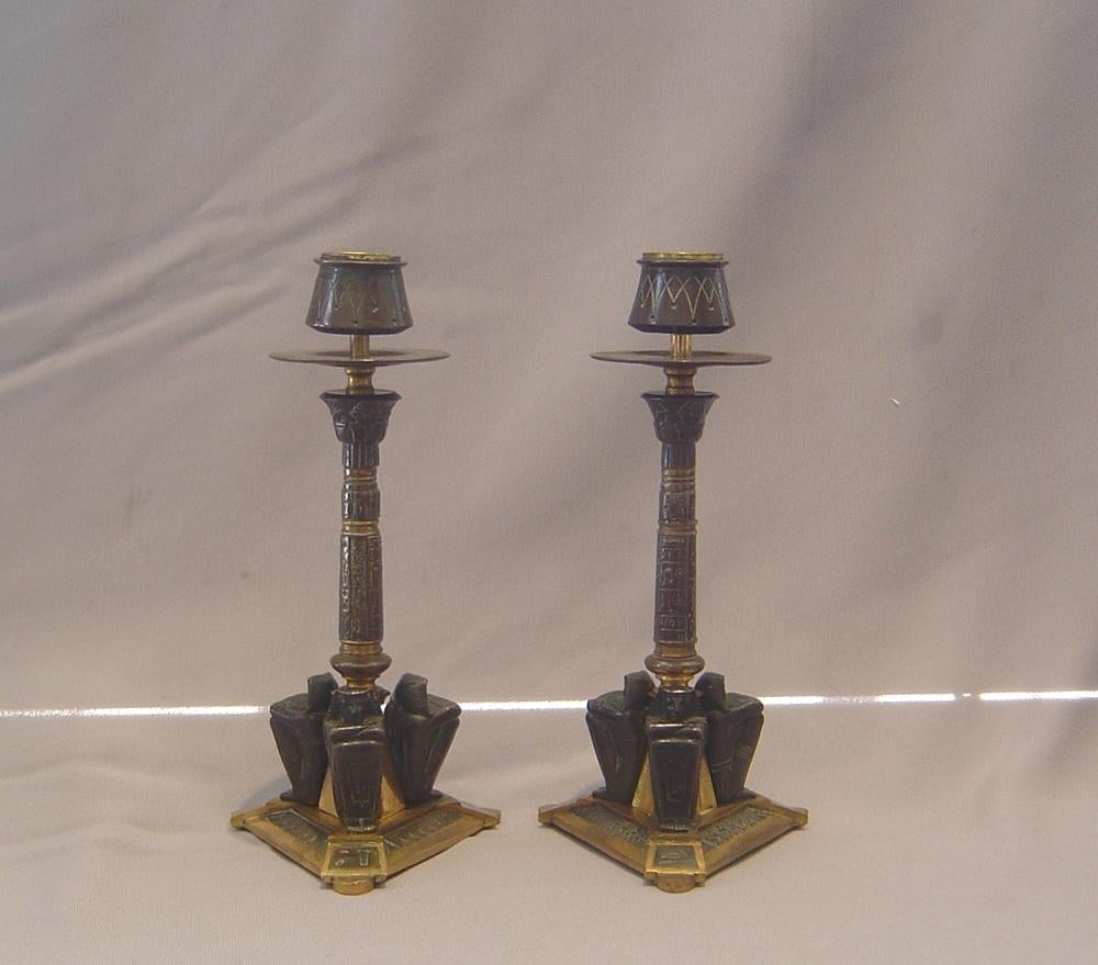 Late 19th Century French 19th century Egyptian revival candlesticks in patinated bronze and ormolu For Sale