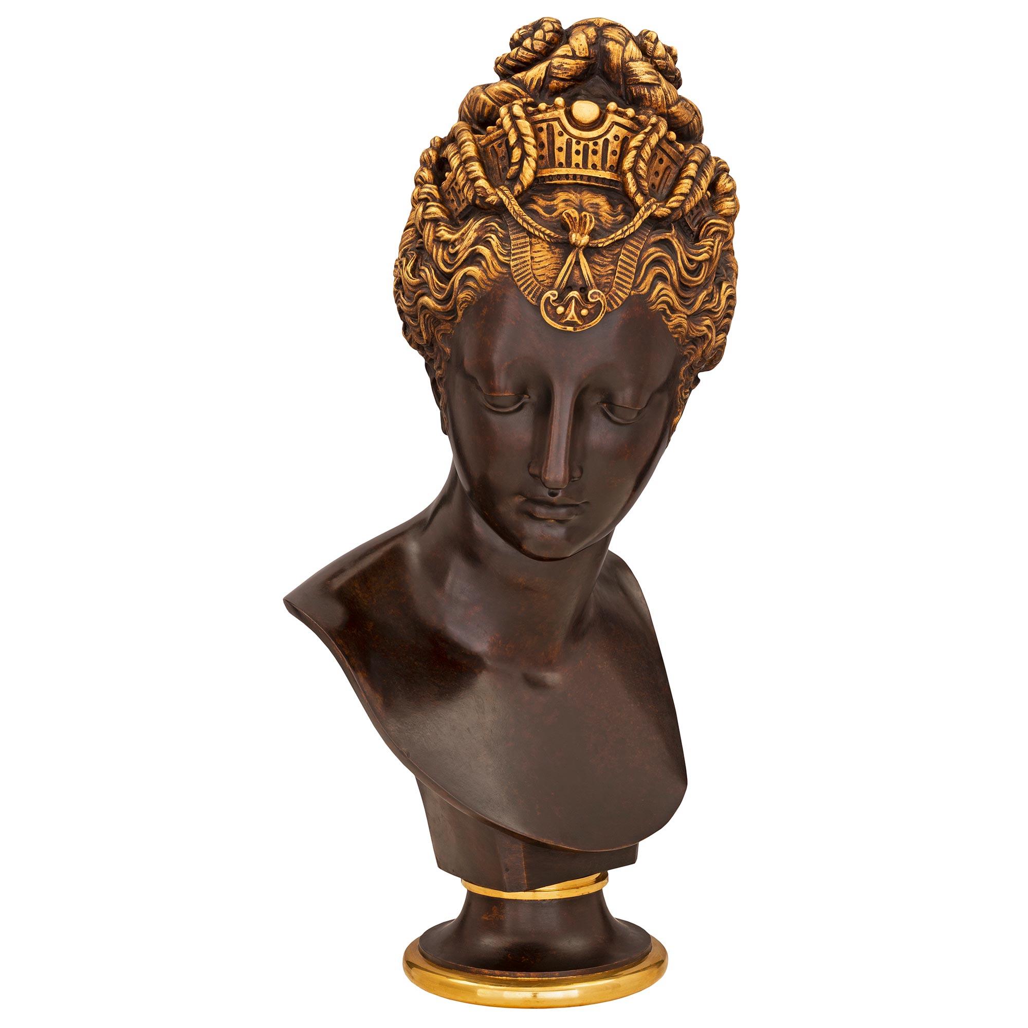 An exceptional French 19th century Egyptian Revival st. Belle Époque period patinated bronze and ormolu bust, signed by F. Barbedienne. The wonderful bust is raised by an elegant circular base with a fine wrap around ormolu band below the socle