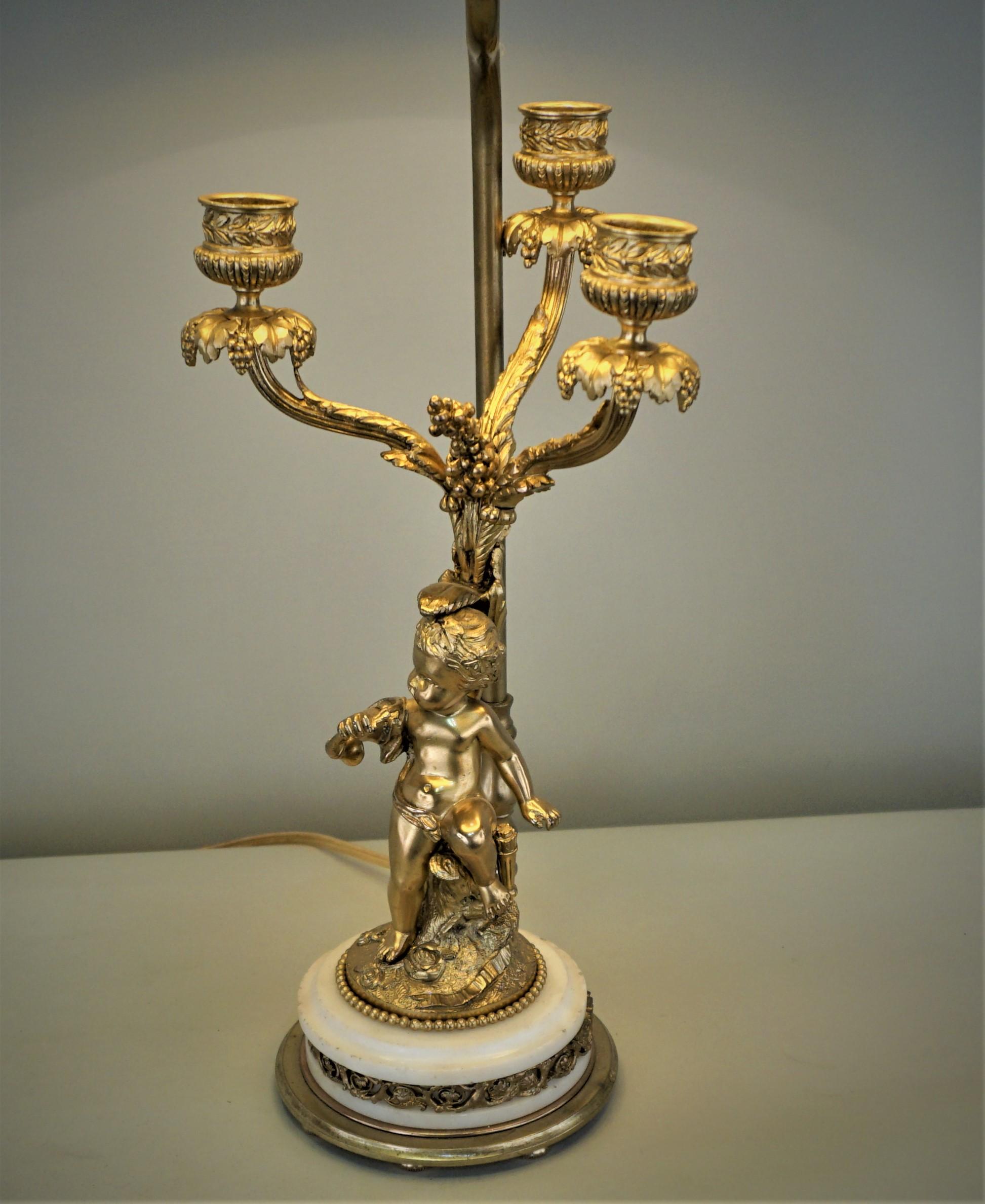 Elegant 19th century candelabra that has been porffecinally electrified and fitted with hardback gold lining lampshade table lamp.
Single 3 way light bulb.