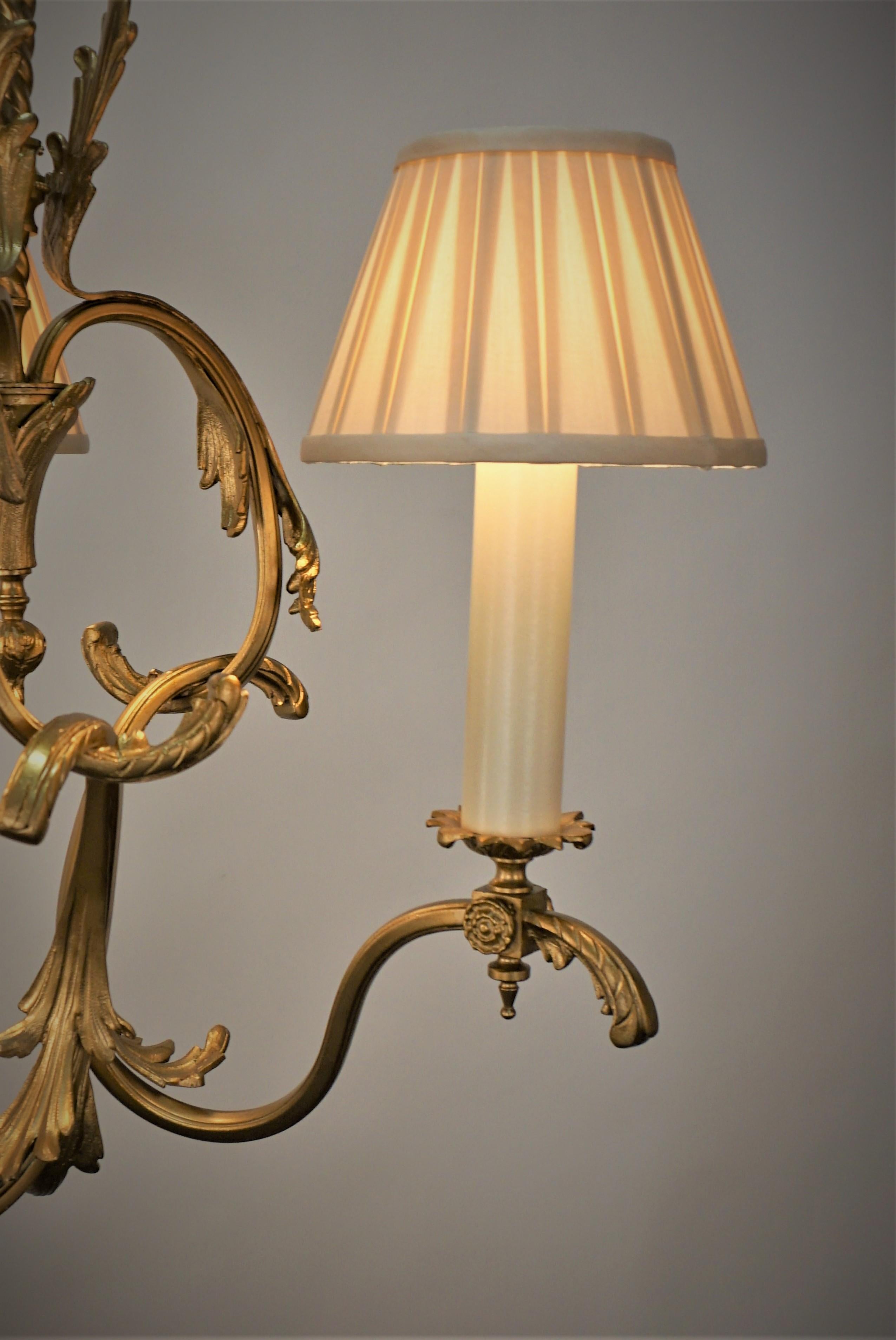 19th Century gilt bronze gas chandelier that professionally electrified and fitted with thee pleated silk lampshades.