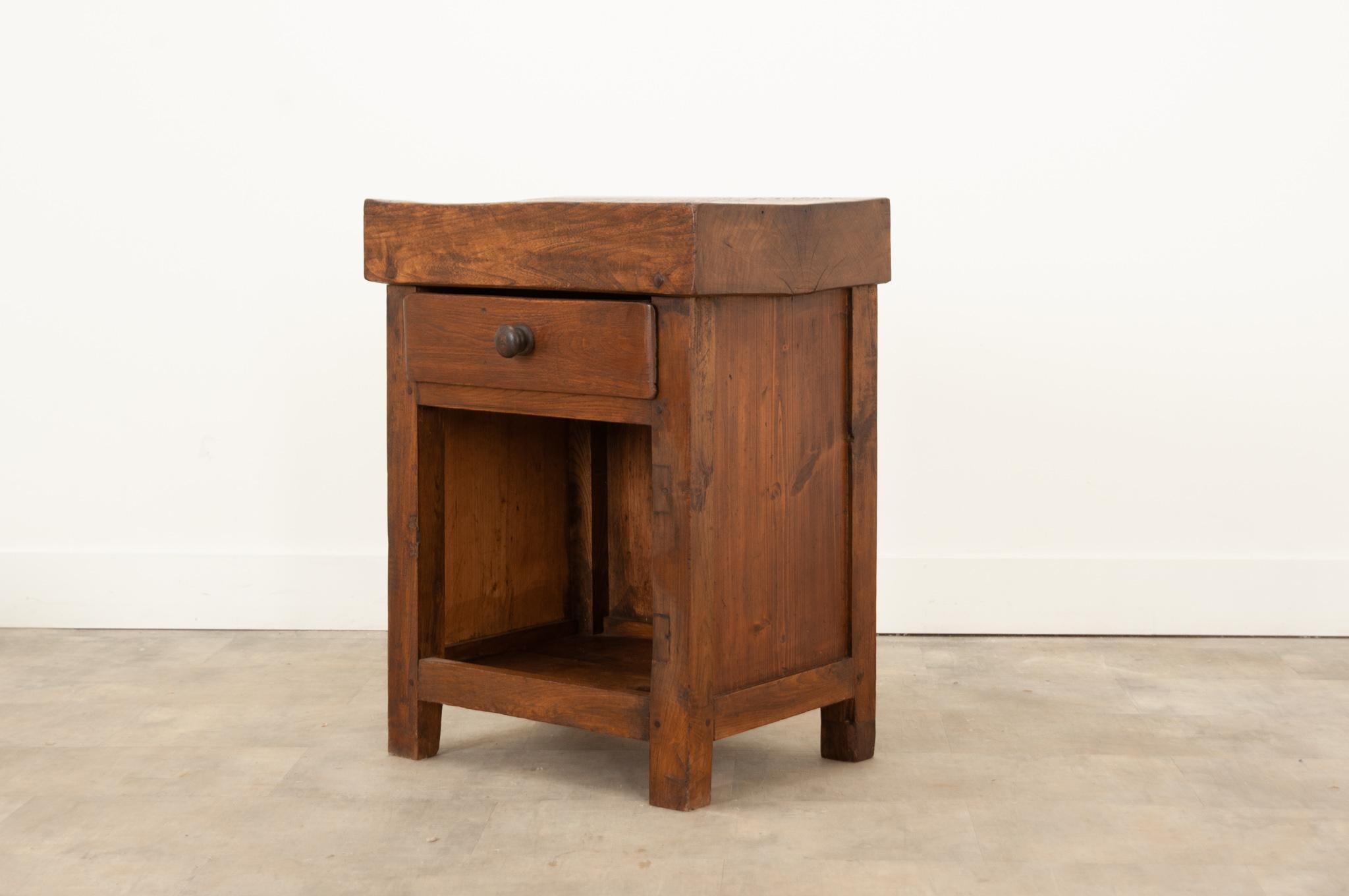 This superb antique chopping block cabinet was hand-crafted in France circa 1850. Wonderfully worn with much time and use, the cut marks from bygone chefs on the thick block top are a prominent feature. Well constructed this cabinet exhibits peg and