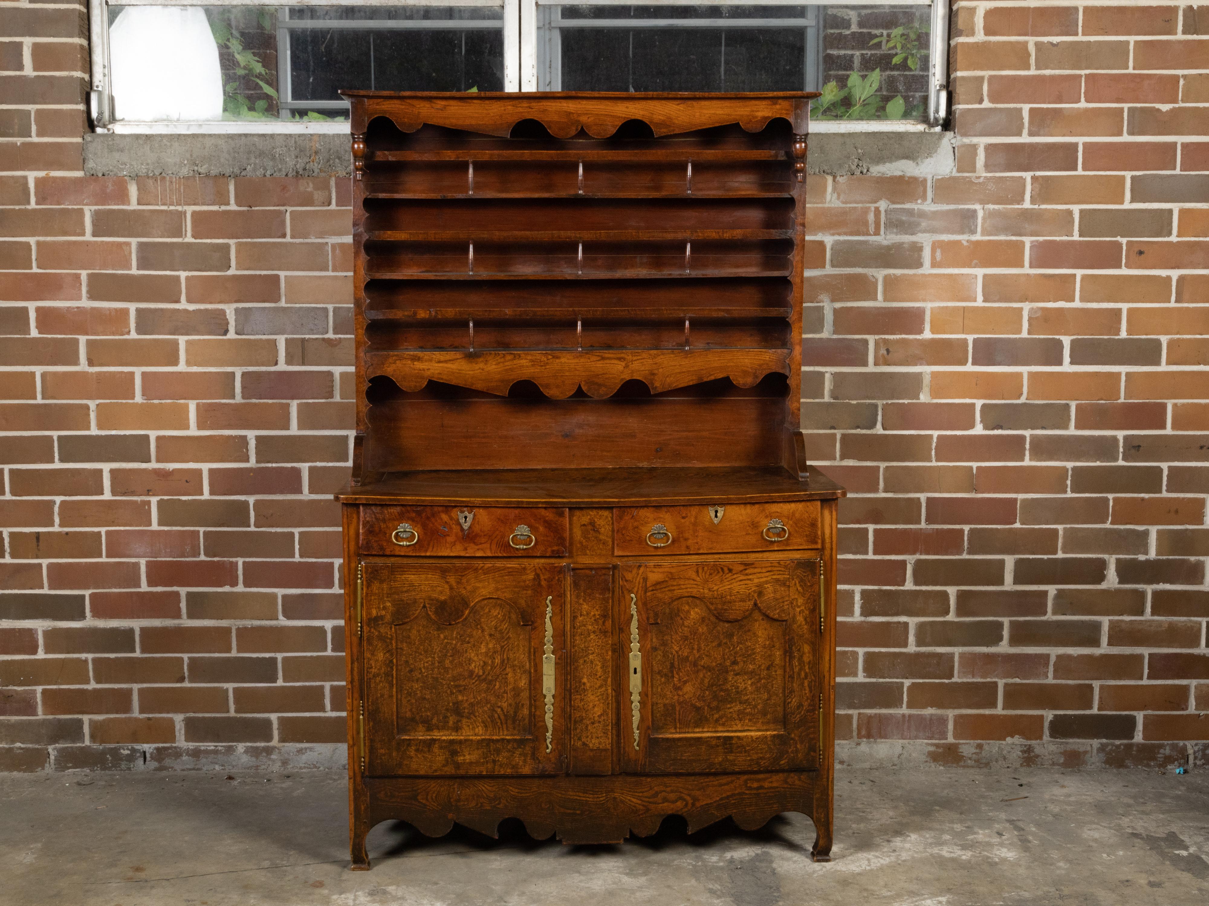 A French elm vaisselier from the 19th century, with open shelves, lower buffet and scalloped accents. Created in France during the 19th century, this elm vaisselier hutch features narrow open shelves in the upper section secured with a thin baluster