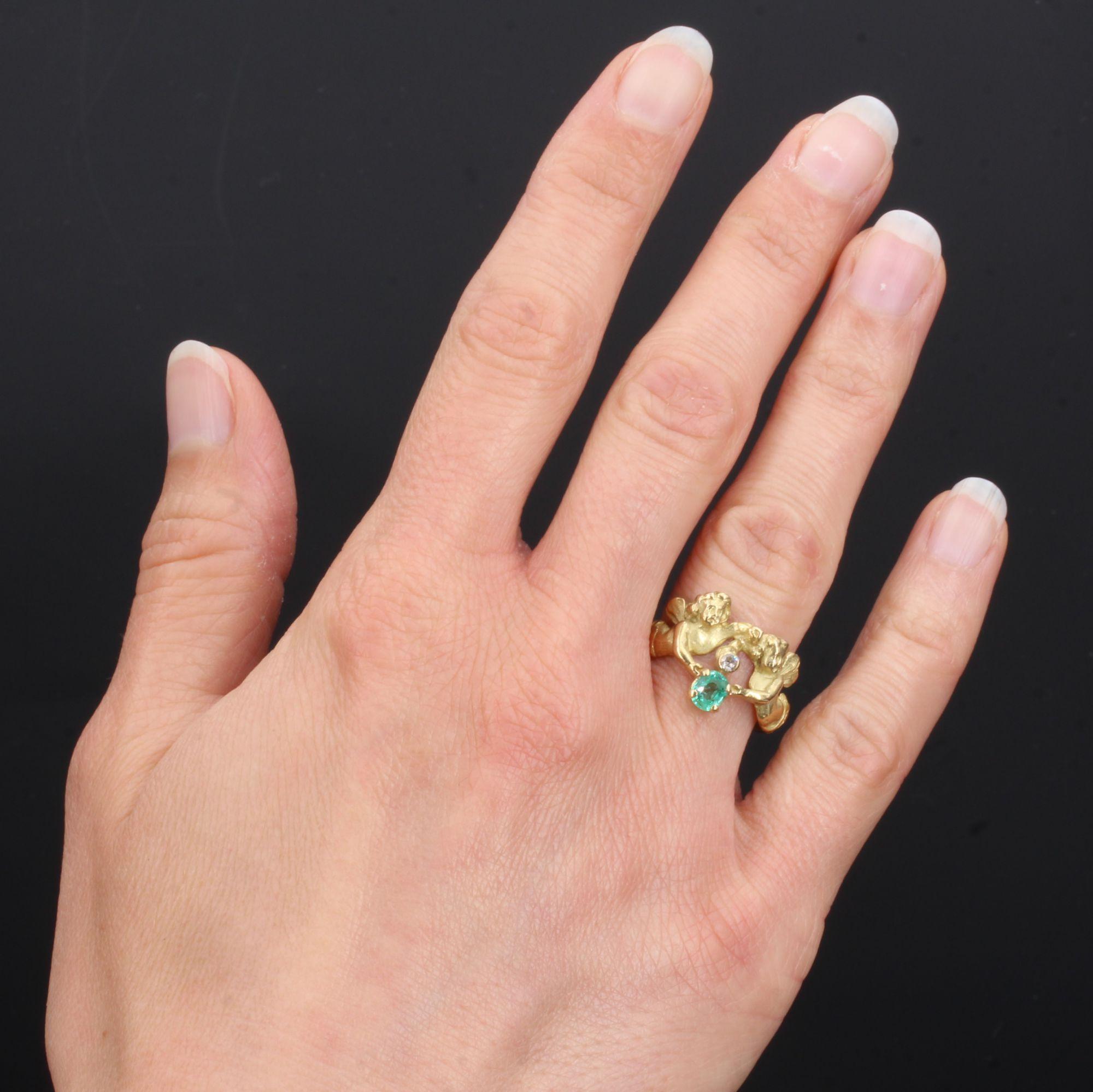 Ring in 18 karat yellow gold, eagle head hallmark.
Splendid antique ring, the ring is formed of two cherubs whose bodies are intertwined and which join on the front to retain in their hands an antique brilliant- cut diamond and a cushion- cut