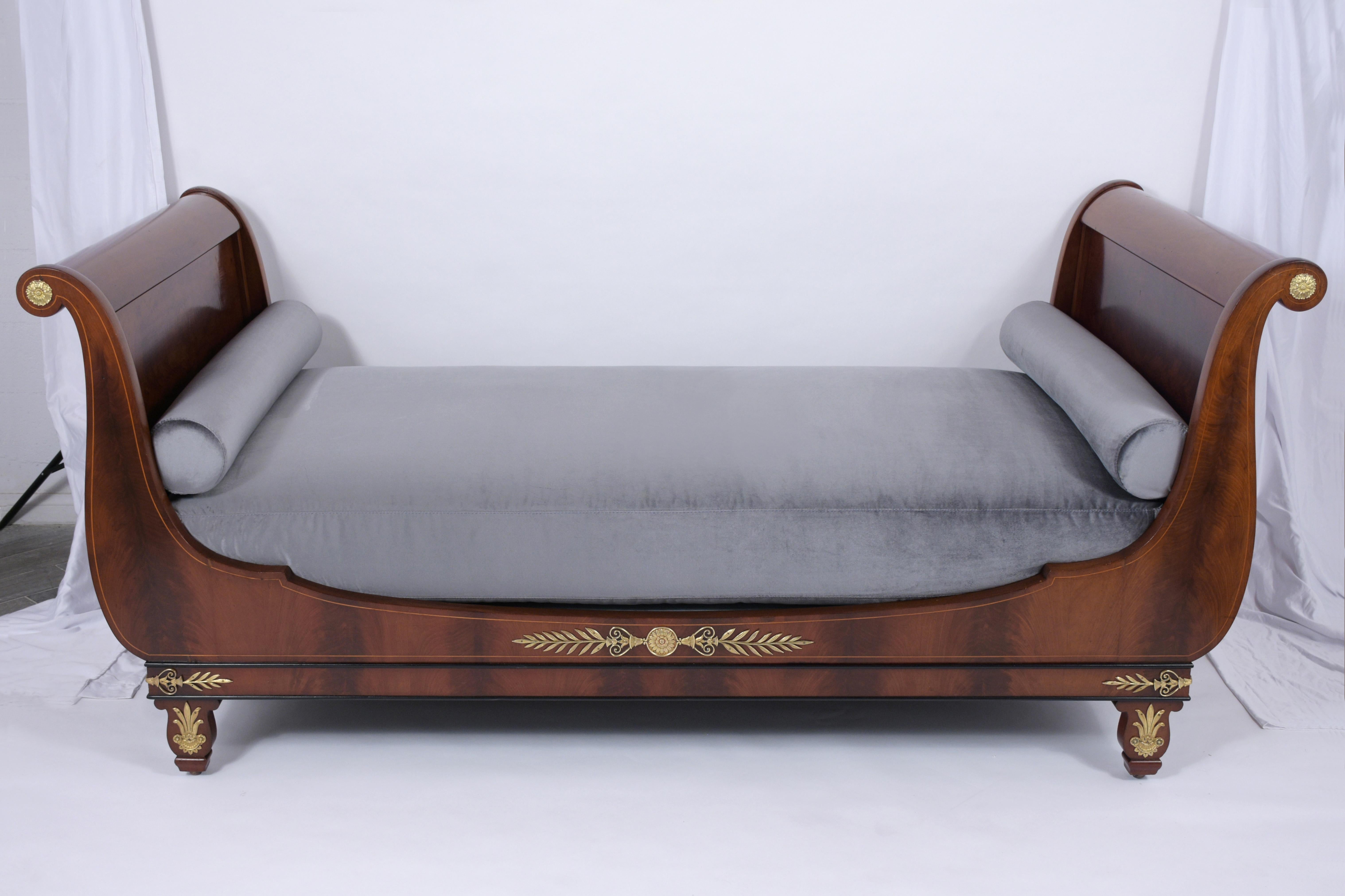 This extraordinary Antique Empire Daybed is beautifully handcrafted out of mahogany wood featuring a scroll design on the head & footboard and has been completely restored. The daybed also features its original dark mahogany color with a beautiful