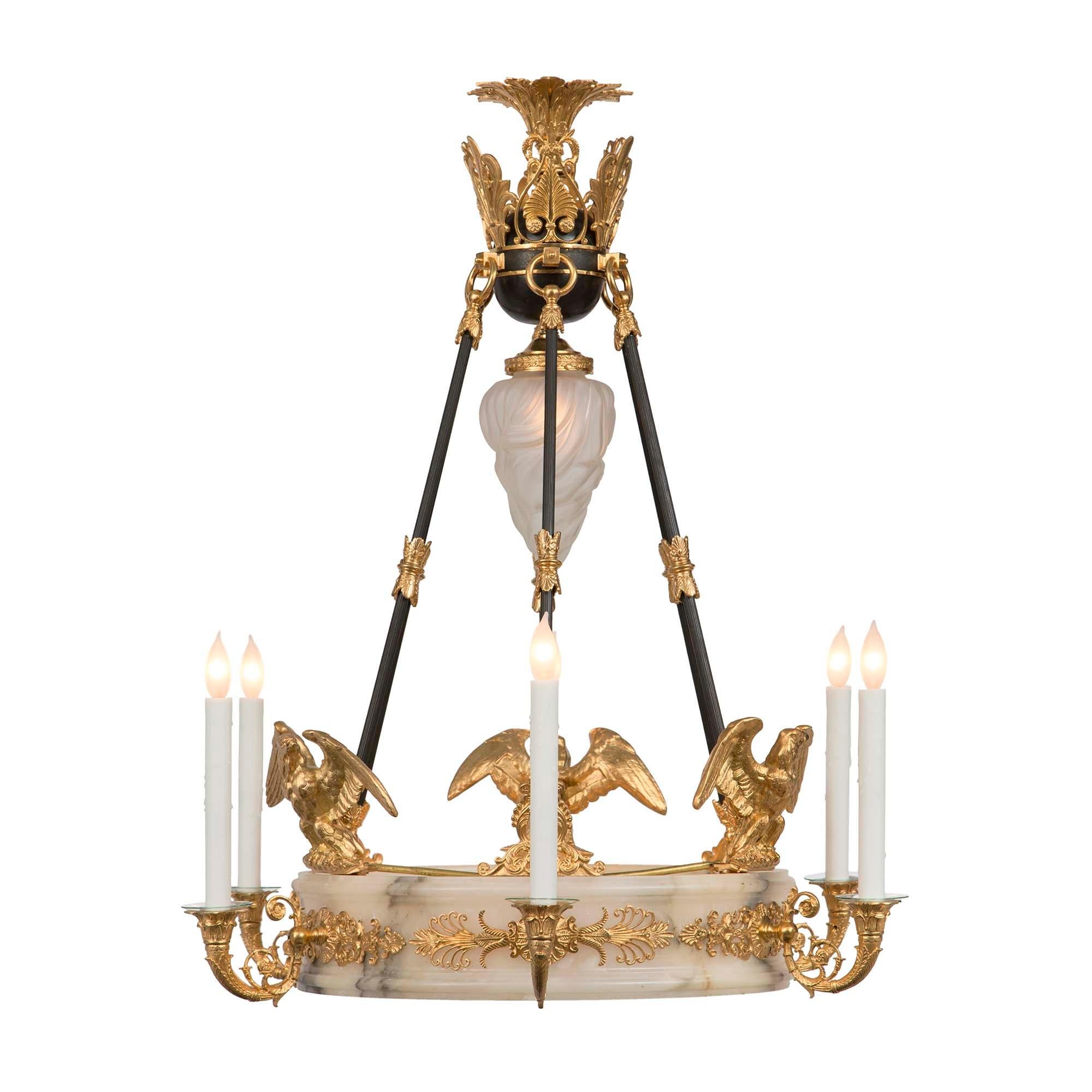 A magnificent French 19th century Empire neo-classical st. alabaster and ormolu chandelier. This six light chandelier has an oval shape alabaster moulded edge base decorated with a pierced ormolu foliate frieze. The six very decorative C scrolled