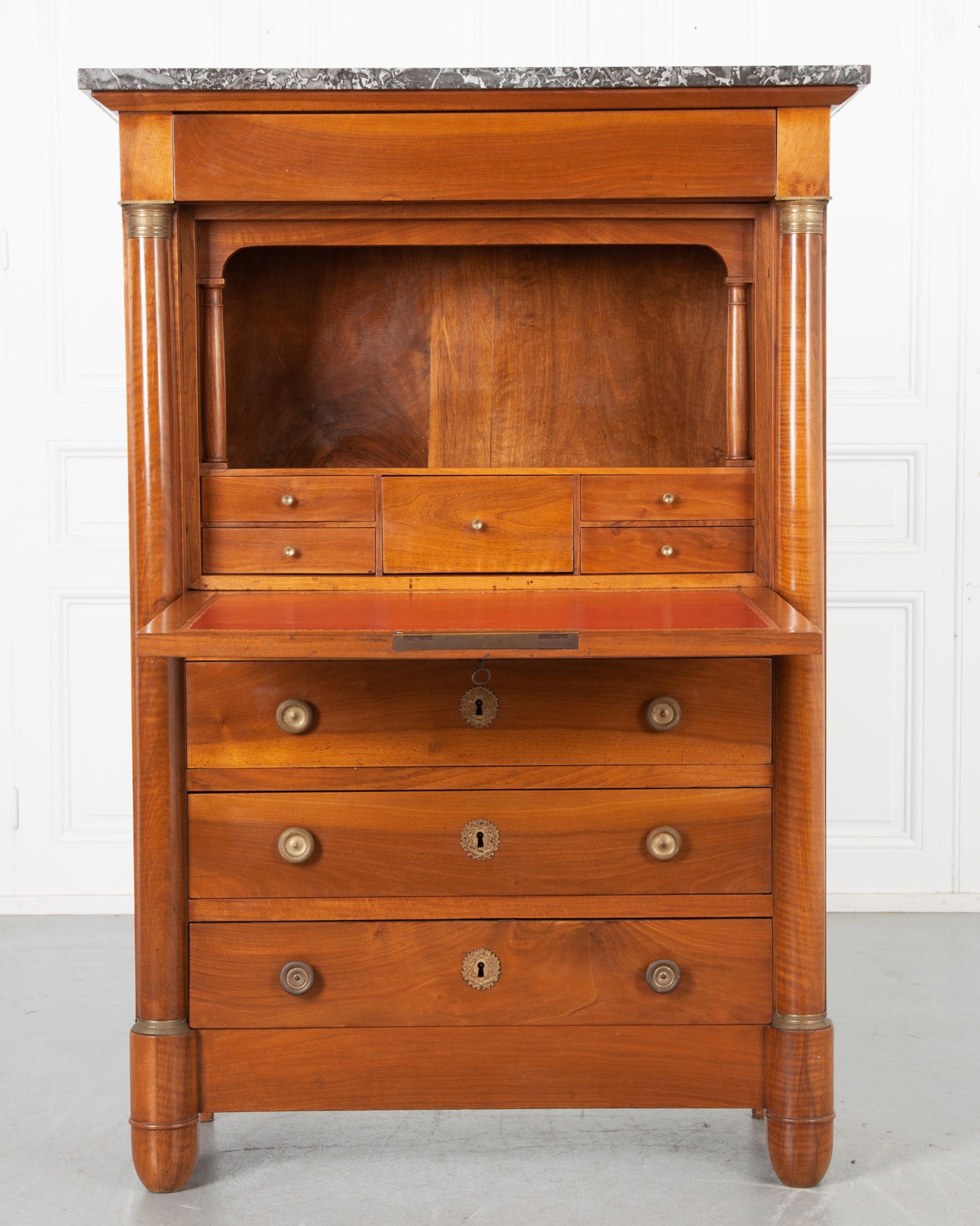 A statley 19th century mahogany secre´taire a` abattant from France, circa 1810. This desk has an exceptional charcoal marble top resting above a single drawer disguised into the apron. Just below the top drawer, the front of the desk folds forward