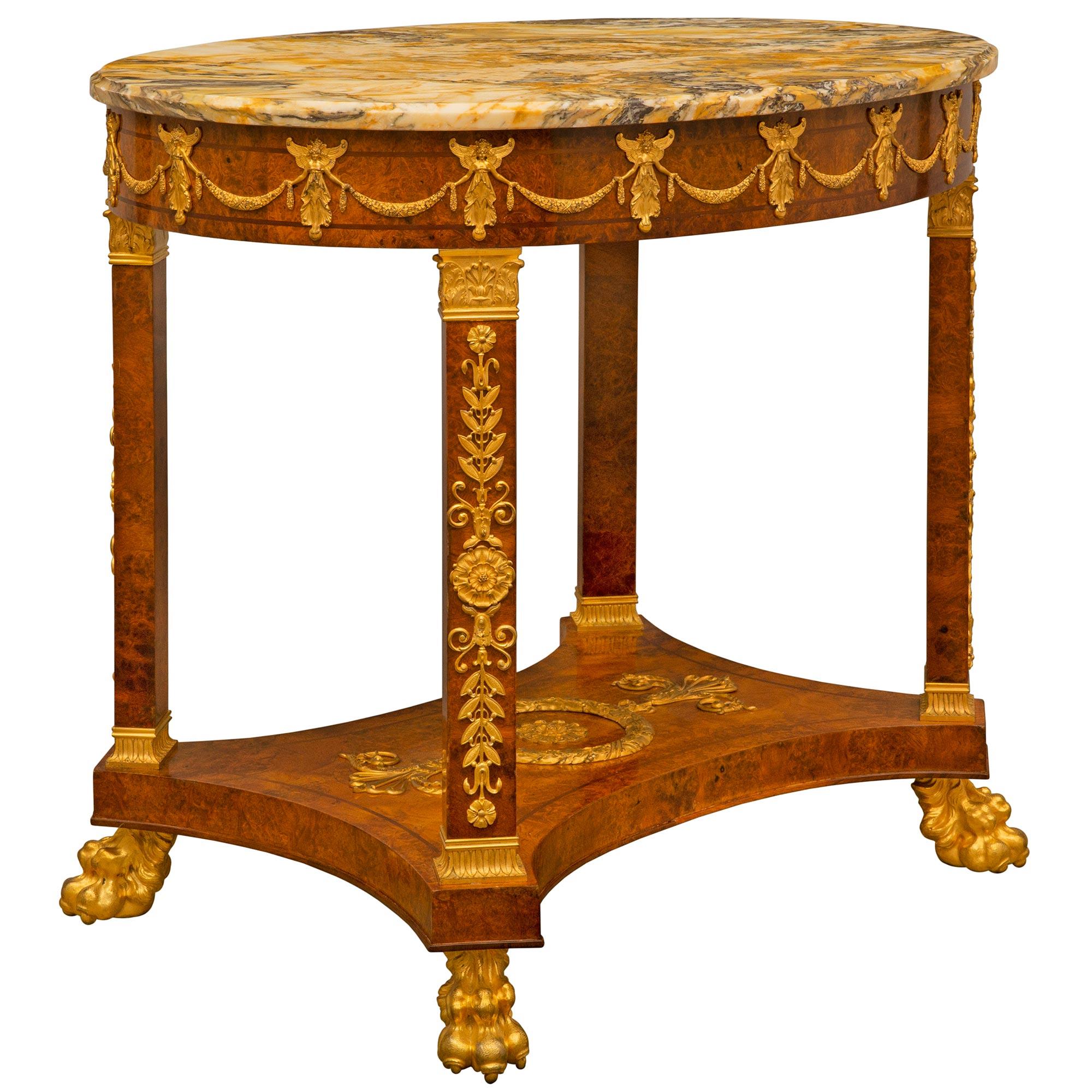 A handsome and extremely high quality French 19th century Empire st. burl Walnut, ormolu and Jaune de Sienne marble side table. The oblong shaped table is raised by impressive richly chased ormolu paw feet below striking column like supports with