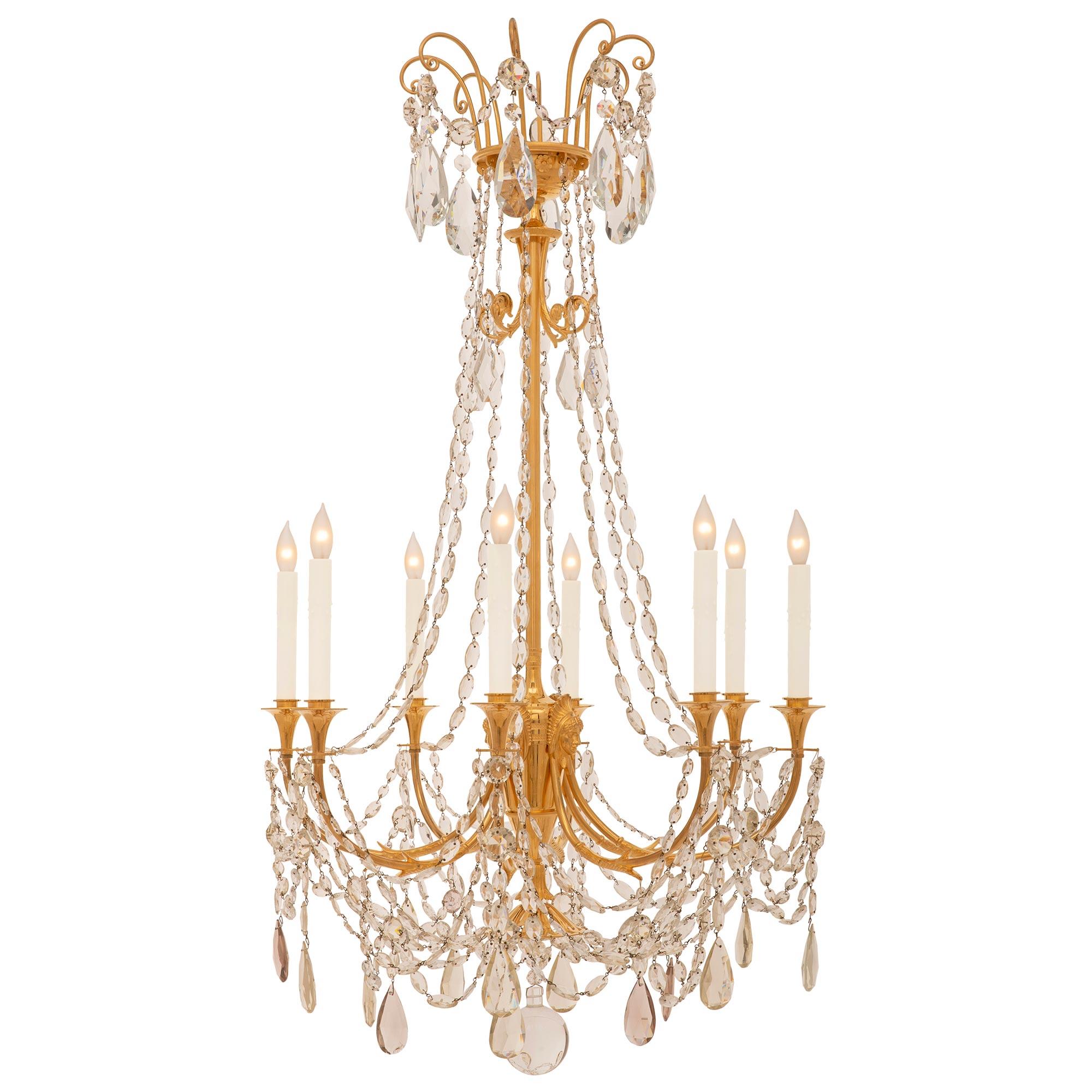 A stunning and extremely elegant French 19th century Empire st. ormolu and Baccarat crystal chandelier. The eight arm chandelier is centered by a striking solid crystal ball below a wonderful array of kite shaped crystal pendants and lovely most