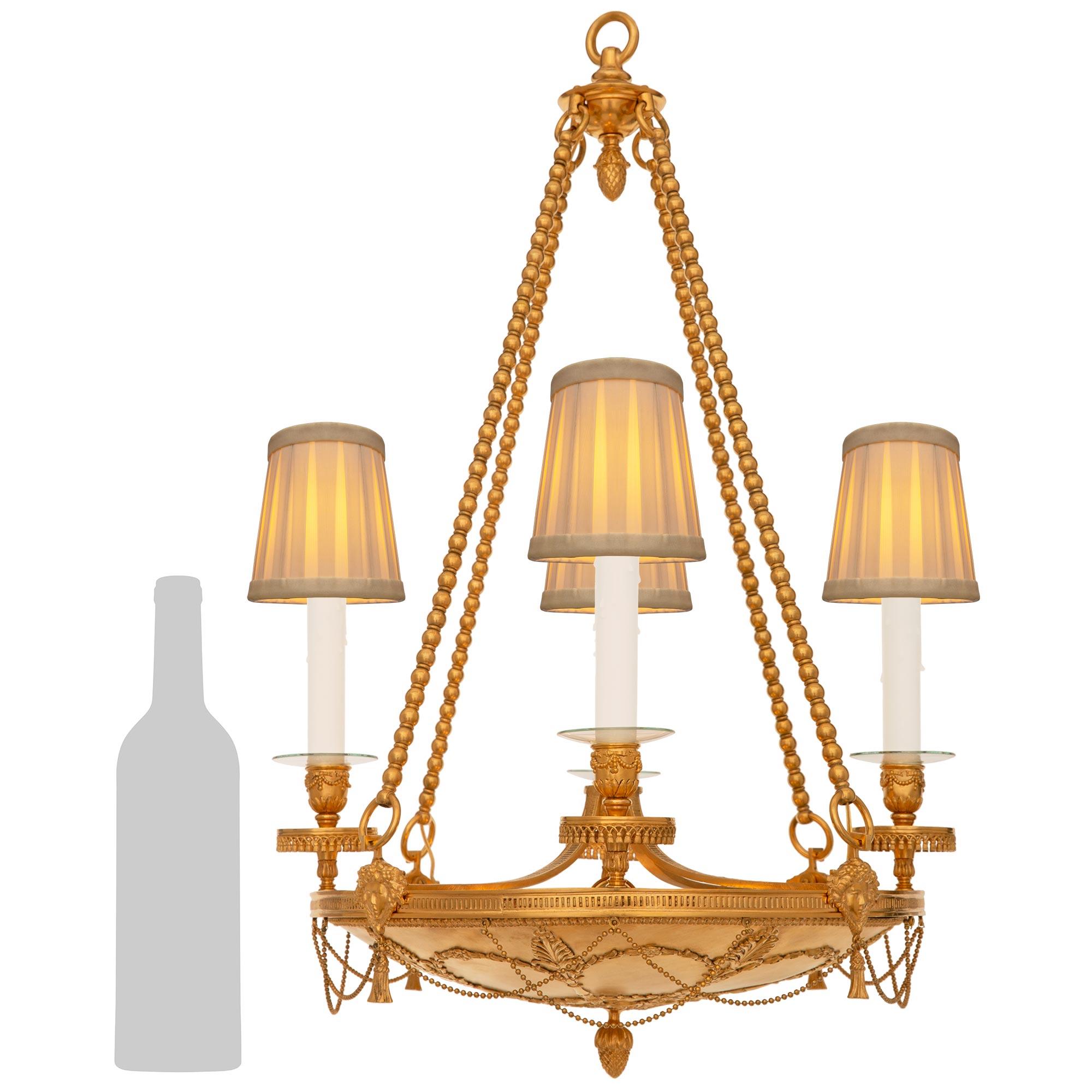 A most elegant and finely detailed French 19th century Empire st. Ormolu chandelier. This exceptional four arm eight light circular chandelier is centered by an Ormolu acorn bottom finial which is surrounded by foliate and palmette designs