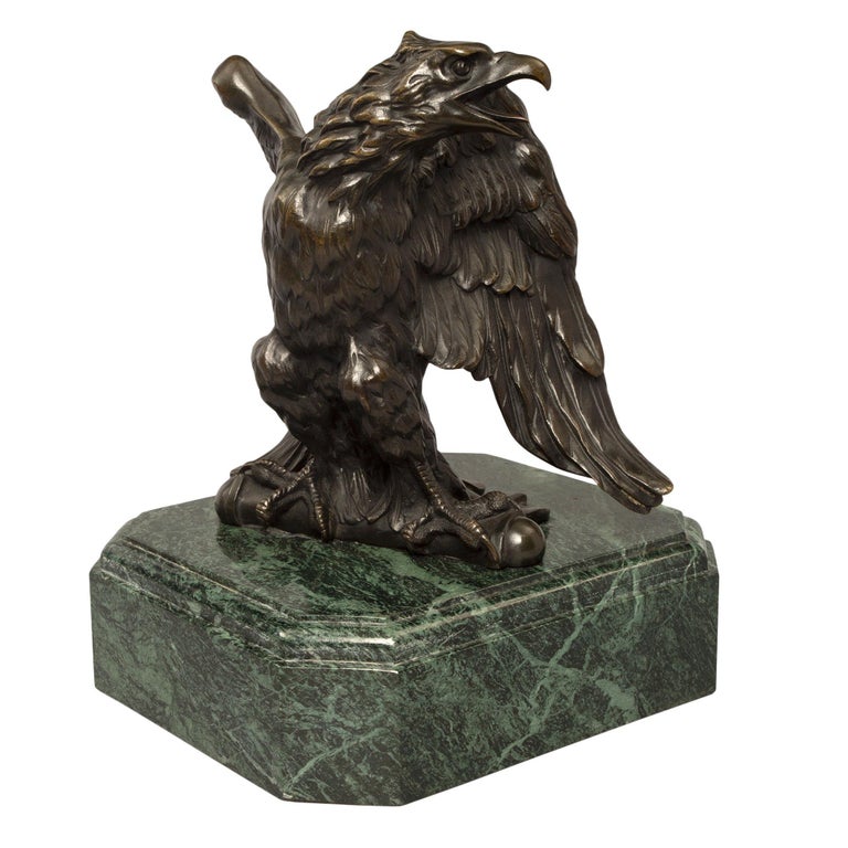 A handsome and high quality French mid 19th century Empire st. patinated bronze eagle on a Vert de Patricia marble base. The richly detailed eagle is raised by a substantial and impressive square mottled Vert de Patricia base with cut corners. The
