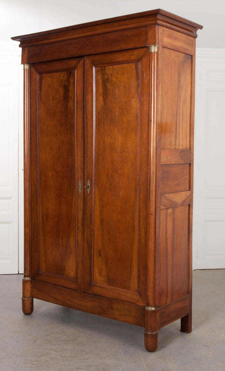 This elegant two-door mahogany armoire is from France, circa 1850s, and having bookmatched mahogany veneers. The doors open to reveal two adjustable shelves and plenty of depth to add a clothing rod. The sides are framed and paneled. The whole is