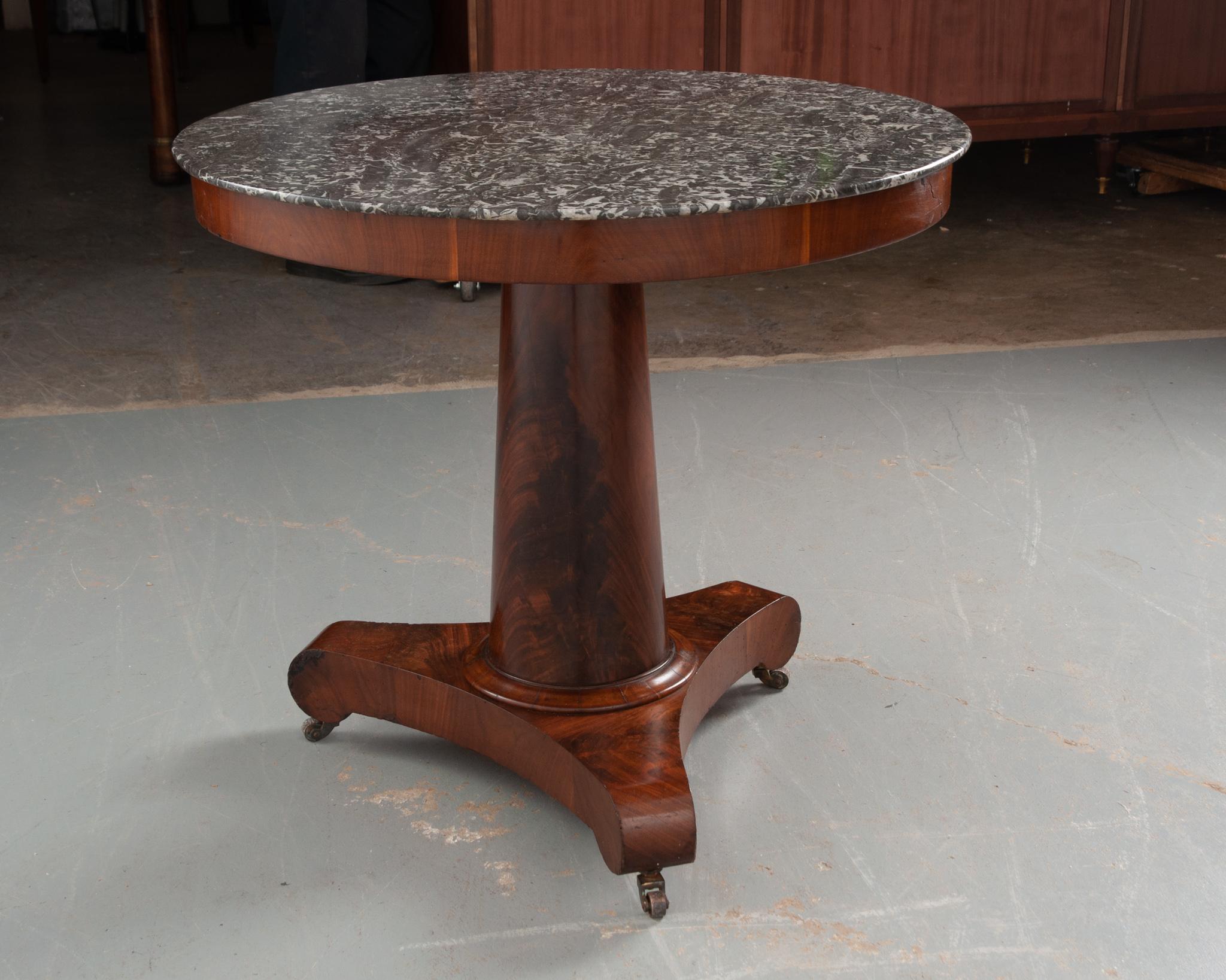 This outstanding French 19th century Empire style center table is the perfect addition to any interior. The gray and white marble top is removable and in great antique condition; it beautifully compliments the rich wood tones of the base. The top is