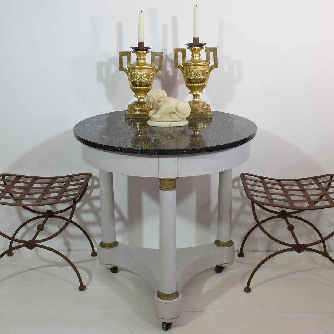 Beautiful Empire style table with it's black marble top and its typical French grey color, 
France, circa 1850-1900. Weathered and paint of later date.