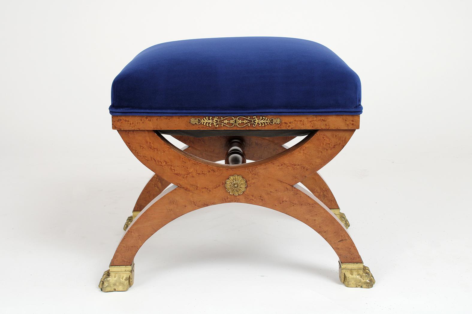 This French 19th century Empire style stool is made out of maple wood covered with a beautiful exotics burl veneer and has been professionally restored. This petite stool has been newly upholstered in blue velvet fabric with double piping detail.
