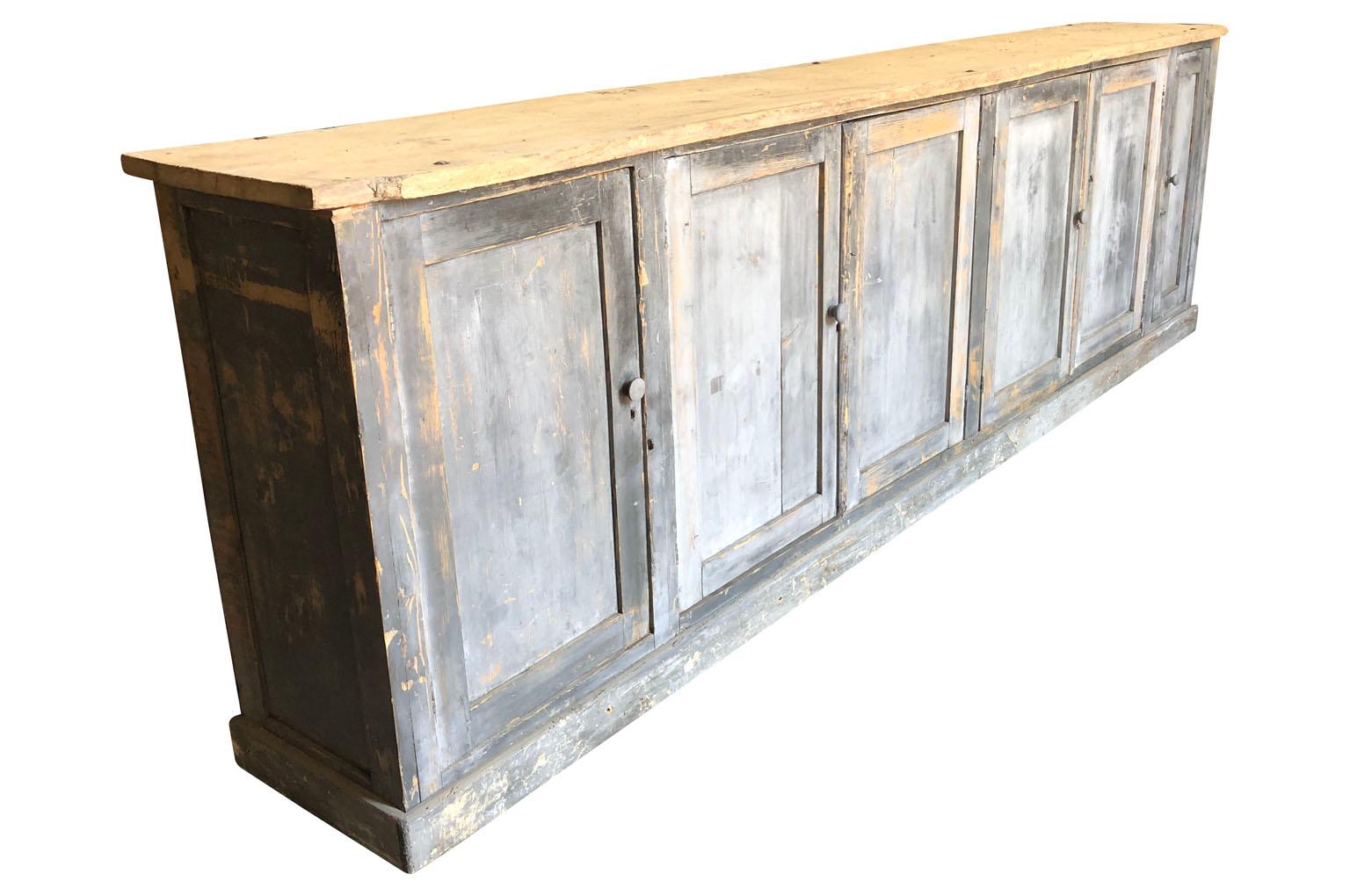 A very handsome later 19th century Enfilade - Buffet from the South of France. Soundly constructed from painted wood with 6 doors and interior shelving. Terrific patina. Wonderful narrow depth.