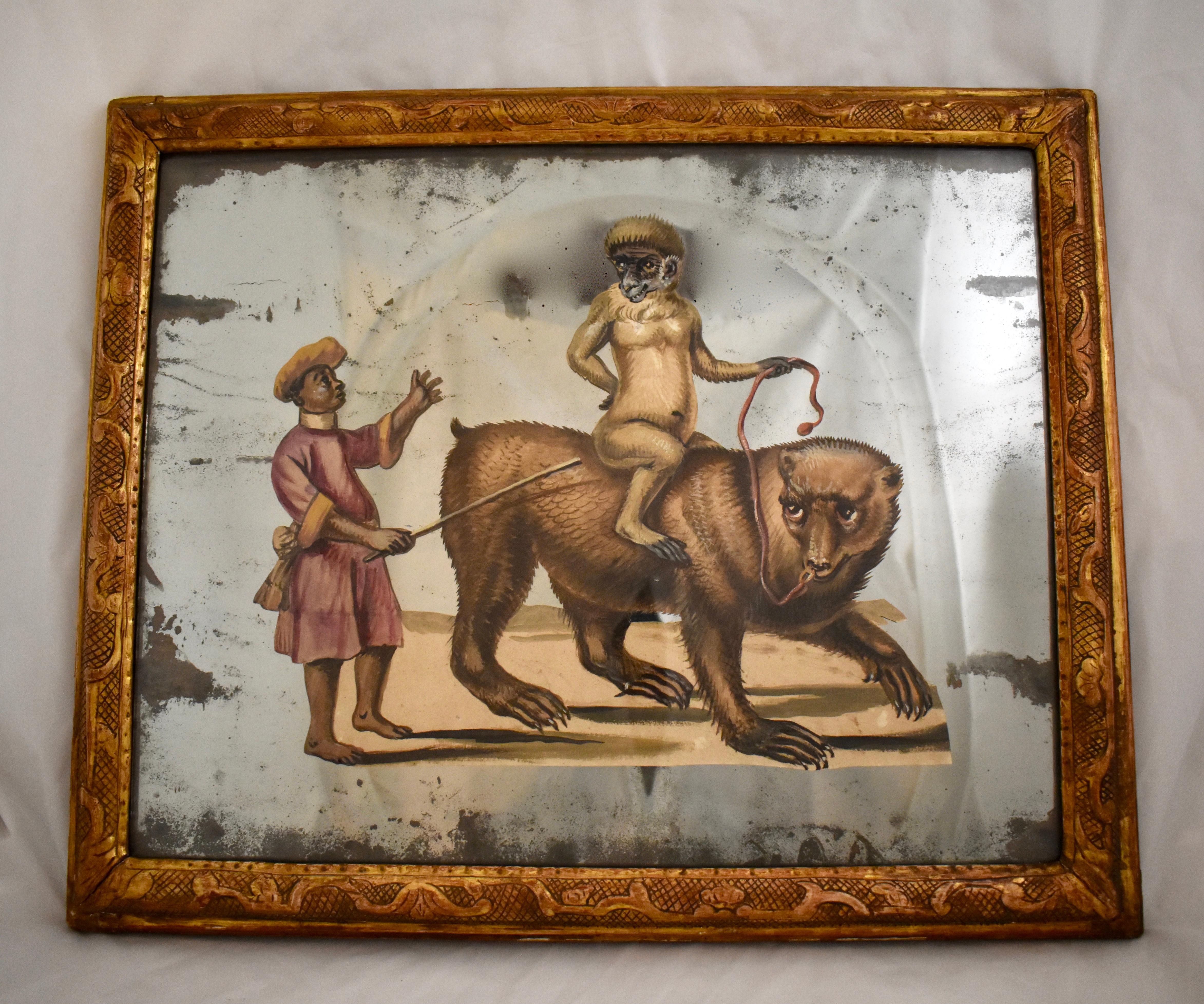 A unique 19th century French exotic themed, hand painted, decoupaged and mirrored depiction of an animal trainer and his monkey riding the back of a bear. One of a pair offered separately, as shown in the last photo. 

The paper figural scene is cut
