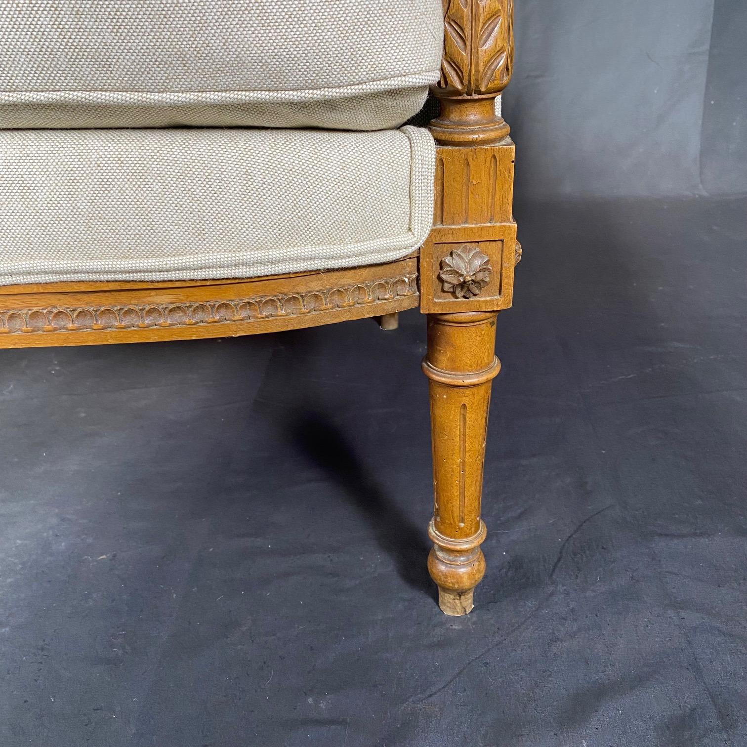 Louis XVI French 19th Century Exquisitely Carved Walnut Bergere with New Upholstery For Sale