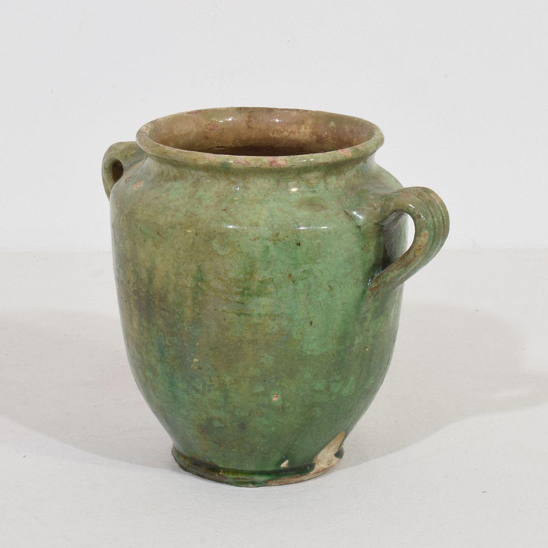Beautiful confit jar with very rare faded green glaze. 
Confit jars were used primarily in the South of France for the preservation of meats such as duck or goose for dishes such as cassoulet or foie gras. The bottom halves were left unglazed, due