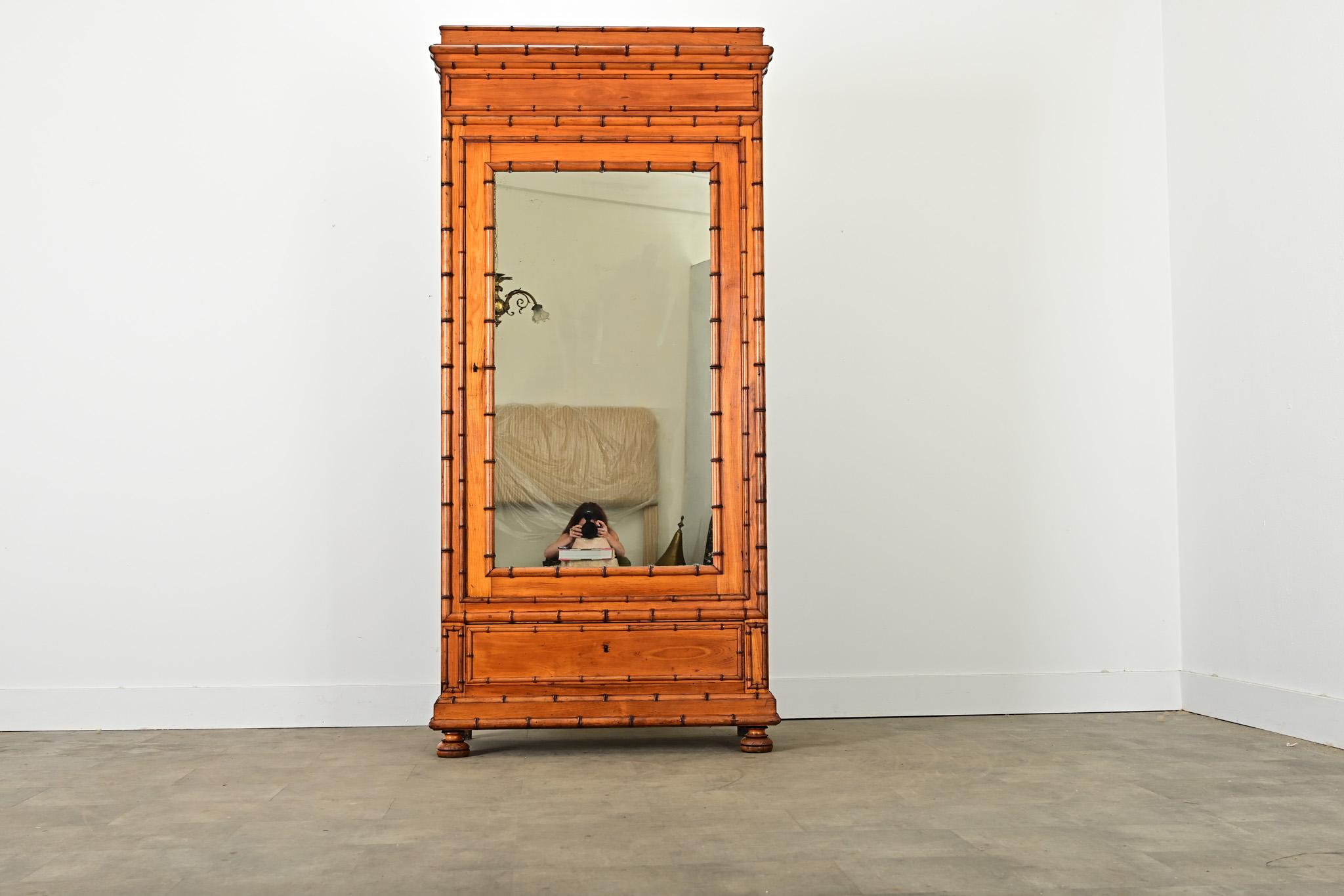 French faux bamboo armoire, late 19th century, carved from pine and stained to give an exotic appearance down to the intermittent nodes along the stalk. This example takes the familiar proportions of a Louis Philippe bibliotheque or armoire and