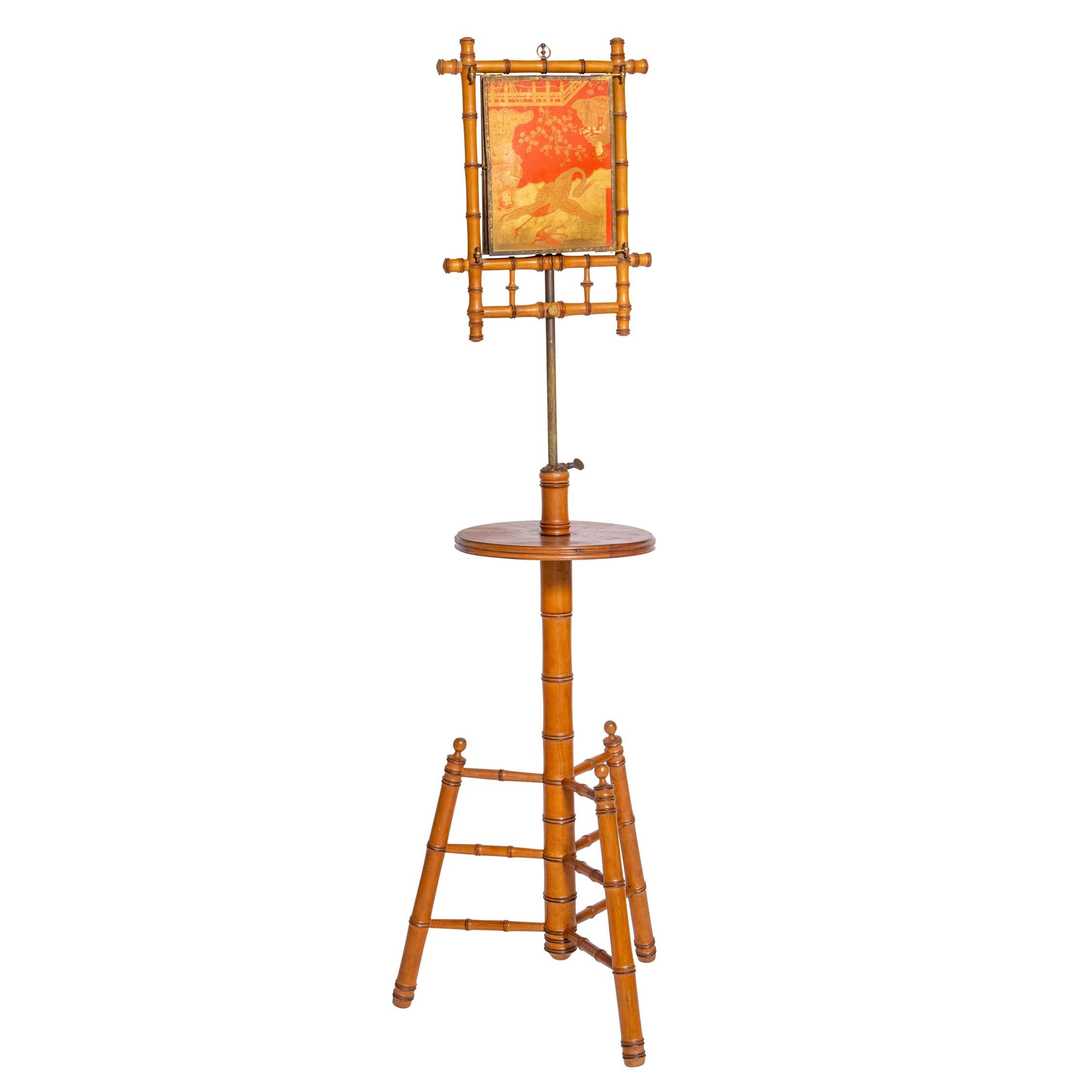 French 19th Century Faux Bamboo Triptych Mirror on Stand
The two lacquered panels with chinoiserie red decoration opening to a central mirror.

Within brass frames with finely chased decoration.

Telescopic pole. Original mirror.

French

Circa