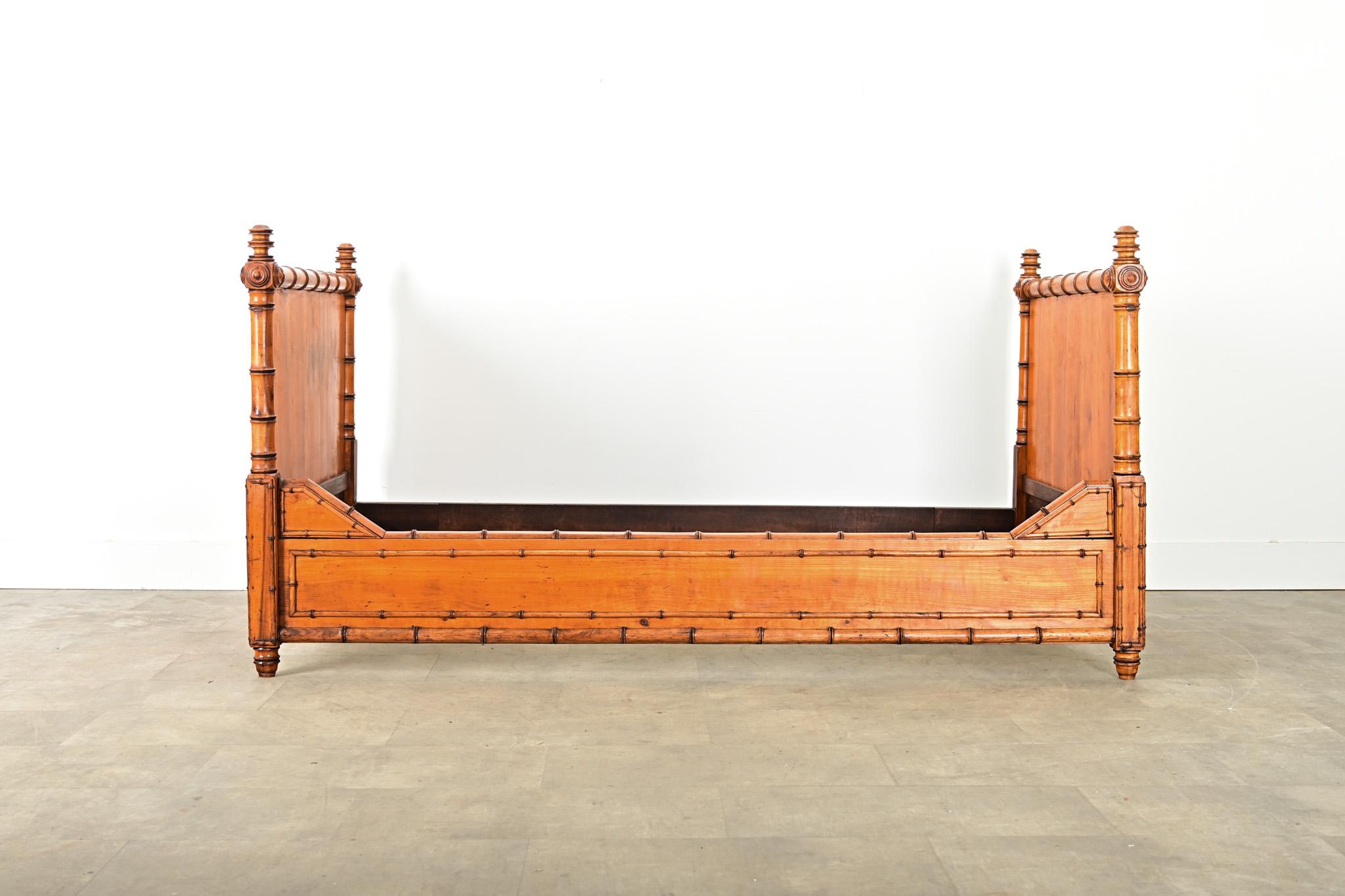 French late 19th century faux bamboo pine bed, reflecting the Aesthetic Movement artistry for organic forms in stylized, decorative ways. Pine planks on the flat surfaces (inside and out) glow with an amber tone in the light, revealing their