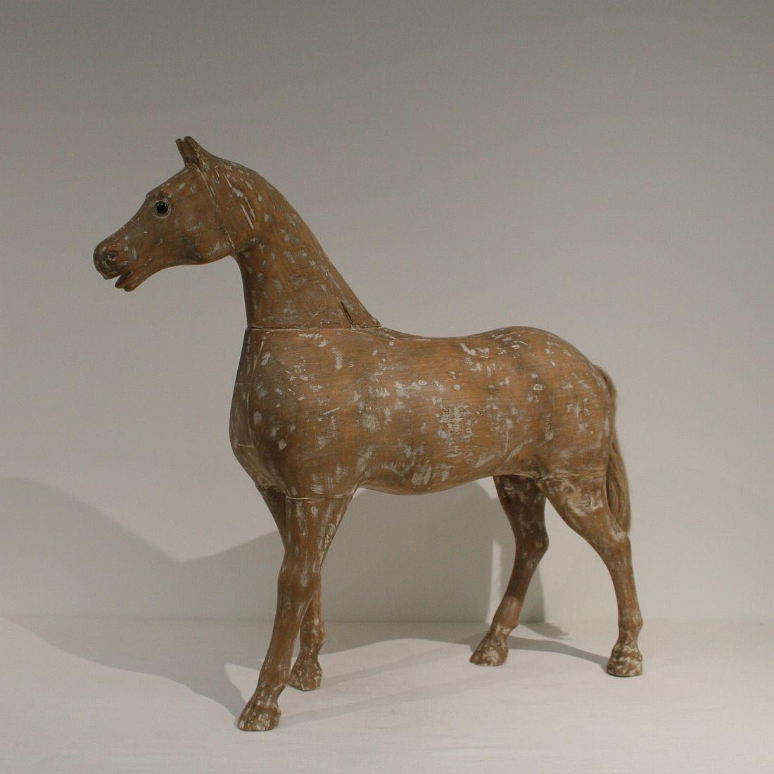 Beautiful wooden horse with glass eyes, France 19th century. Weathered, small losses and old repairs.
 
