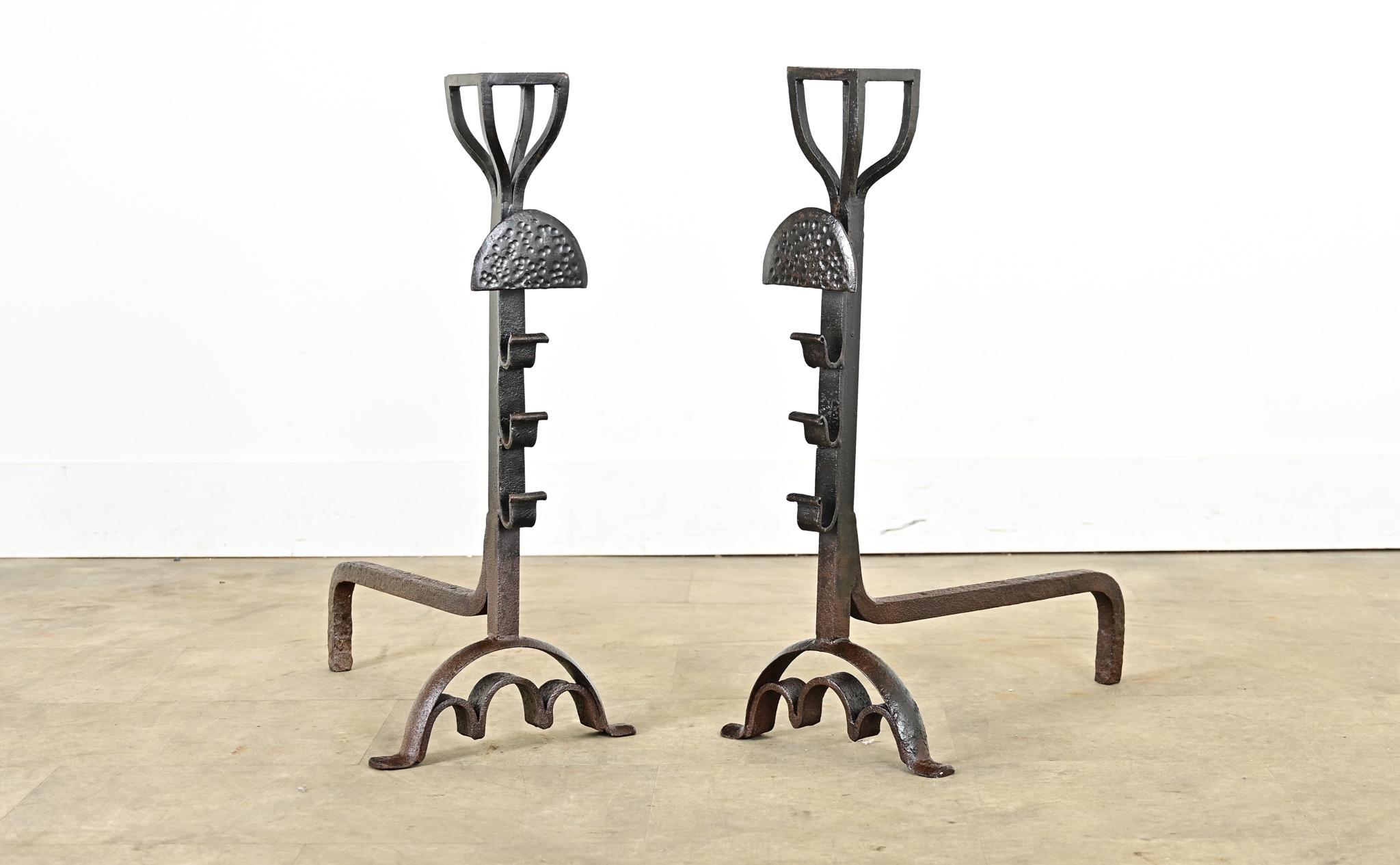 A sculptural pair of French 19th century cast iron fireplace andirons, or chenets, that hold as much fascination as the roaring fire behind them. Stylistically they fall between the brutalism of Gothic Revival and creative expression of Art Nouveau: