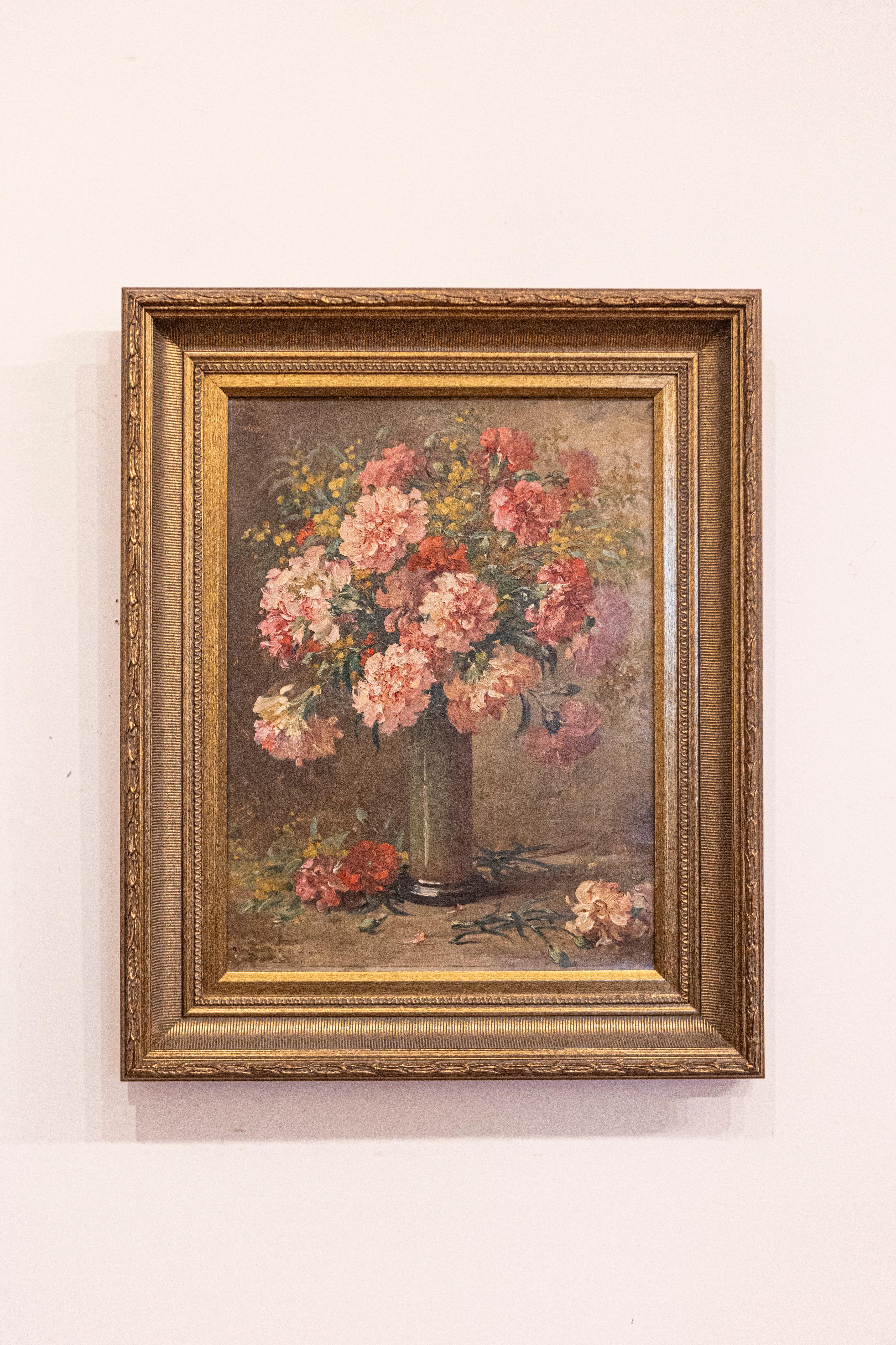 A French floral still-life oil on canvas painting from the 19th century, set inside a giltwood frame. This French still-life painting features an exquisite bouquet of pink flowers displayed in an elegant tall vase. The various shades of pink that
