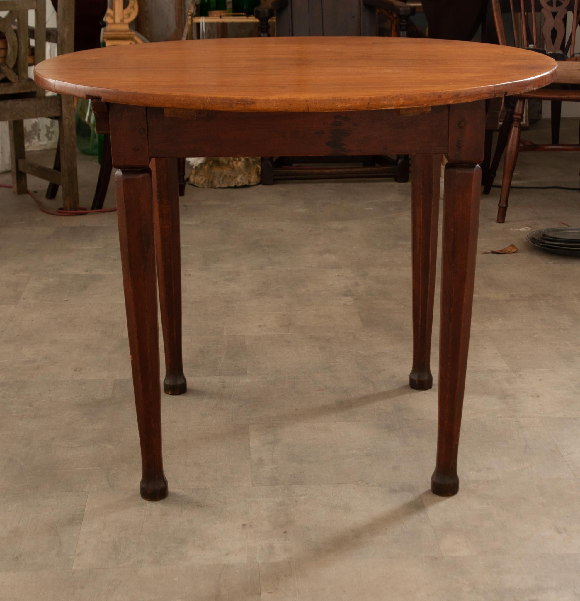 A wonderful small table with a lightly toned fruitwood top from 19th Century France. This smaller table could be used as a dining or breakfast room table for two. It could also be used as a side or occasional table next to a chair or sofa.  It has a