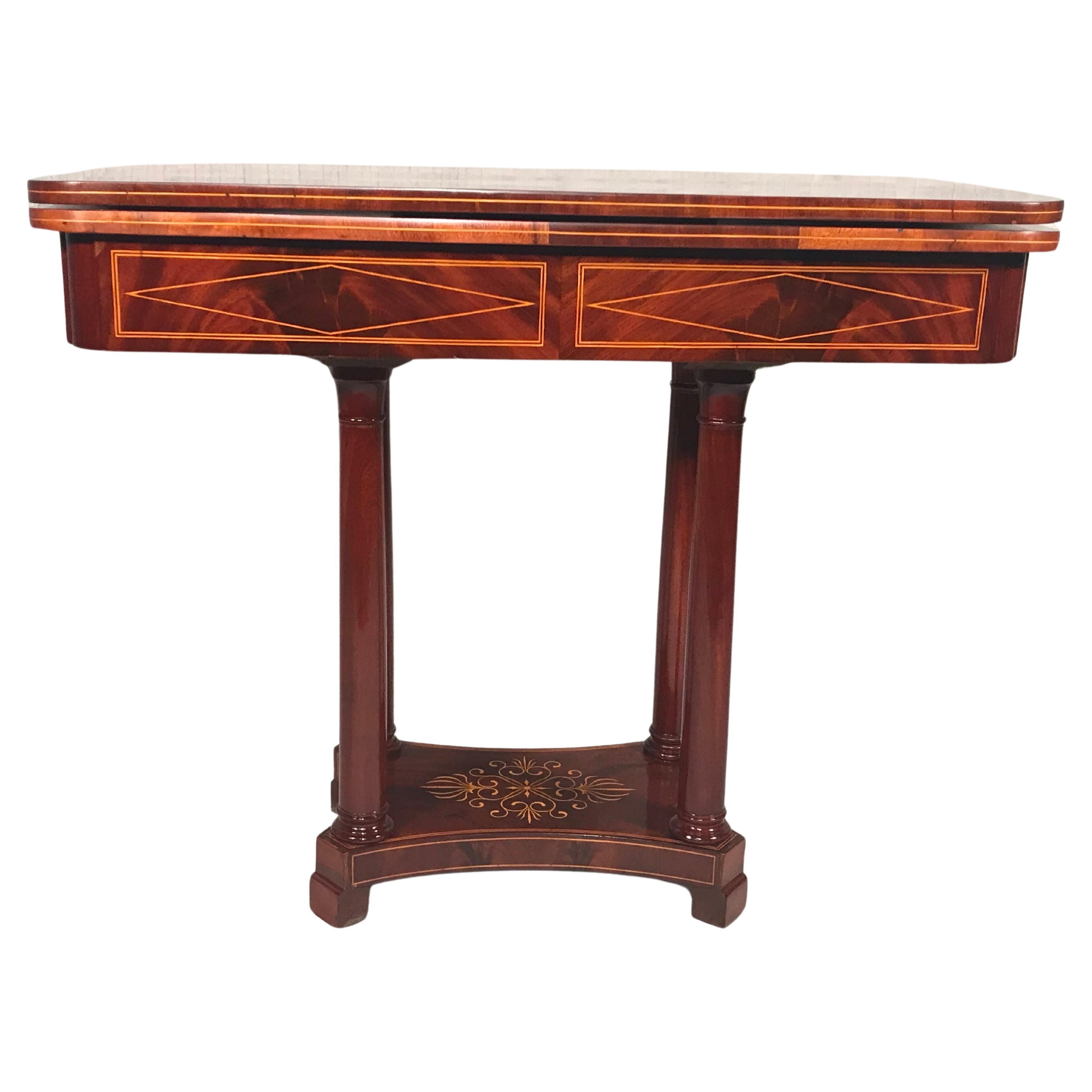 mmerse yourself in the charm of this delightful 19th-century game table, a French masterpiece hailing from the Restoration period around 1830. Adorned with a captivating mahogany veneer featuring intricate floral inlays on the base and inlaid band