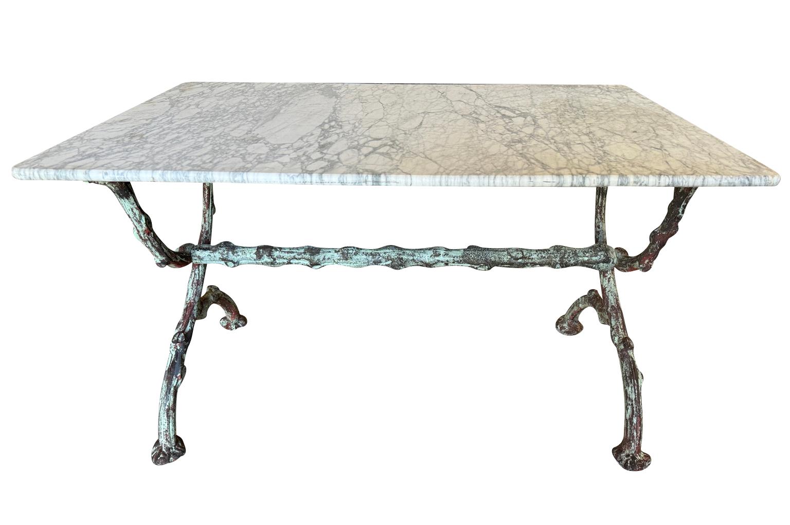 An outstanding French 19th century Garden Console Table. Wonderfully constructed with its original marble top and iron base in Branchage motif - Faux Bois. Outstanding patina. Perfect for any garden or interior. Very chic. 