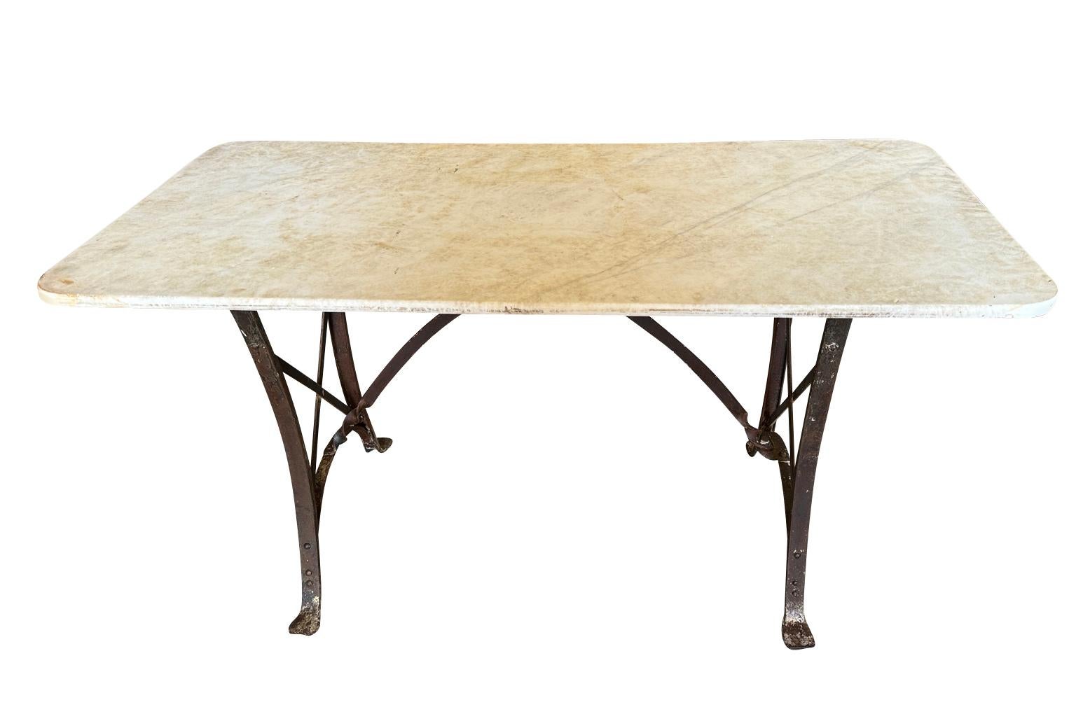 A very elegant late 19th century Garden Console Table from the South of France.  Beautifully constructed with its original marble top and an iron base in the Eiffel style.  Very chic with excellent patina.