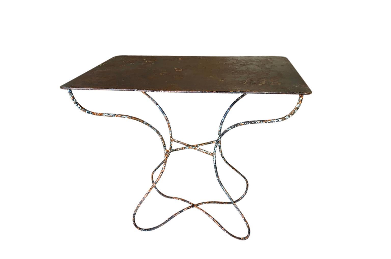 A wonderful 19th century garden table from the Provence region of France. Soundly constructed from iron with a very beautiful and unusually shaped legs. Very sturdy with wonderful patina.