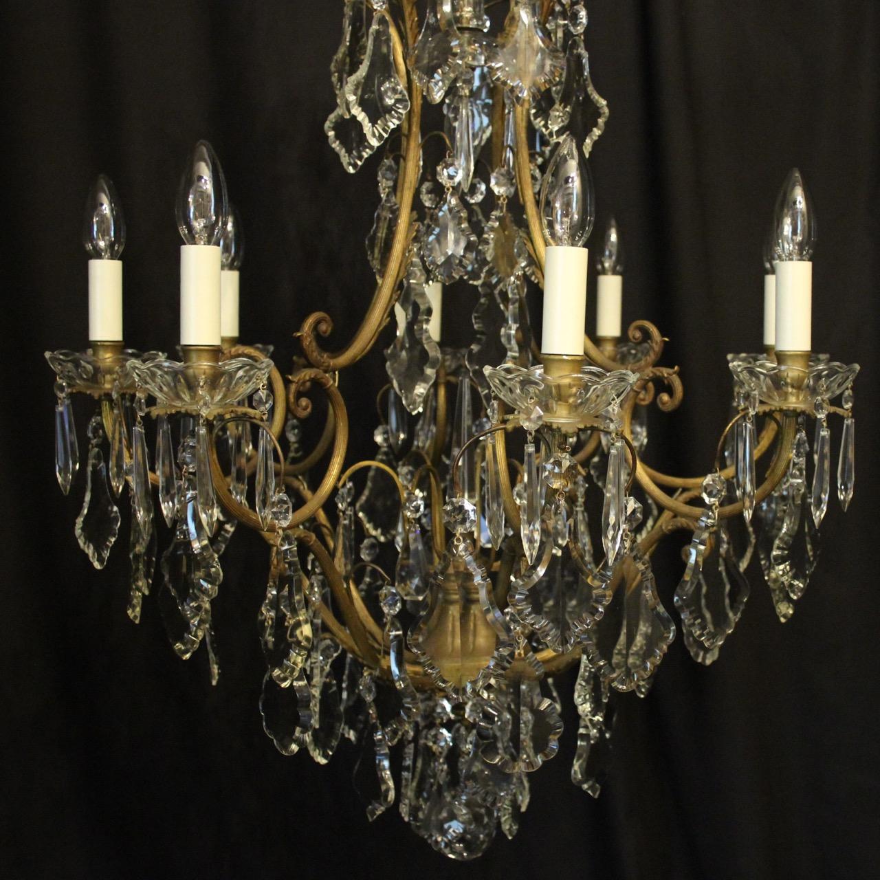 A French gilded cast brass and crystal 9-light birdcage form antique chandelier, the 8 reeded scrolling arms with glass bobeche drip pans and bulbous candle sconces, issuing from an foliated cage form interior with a single inverted light fitting