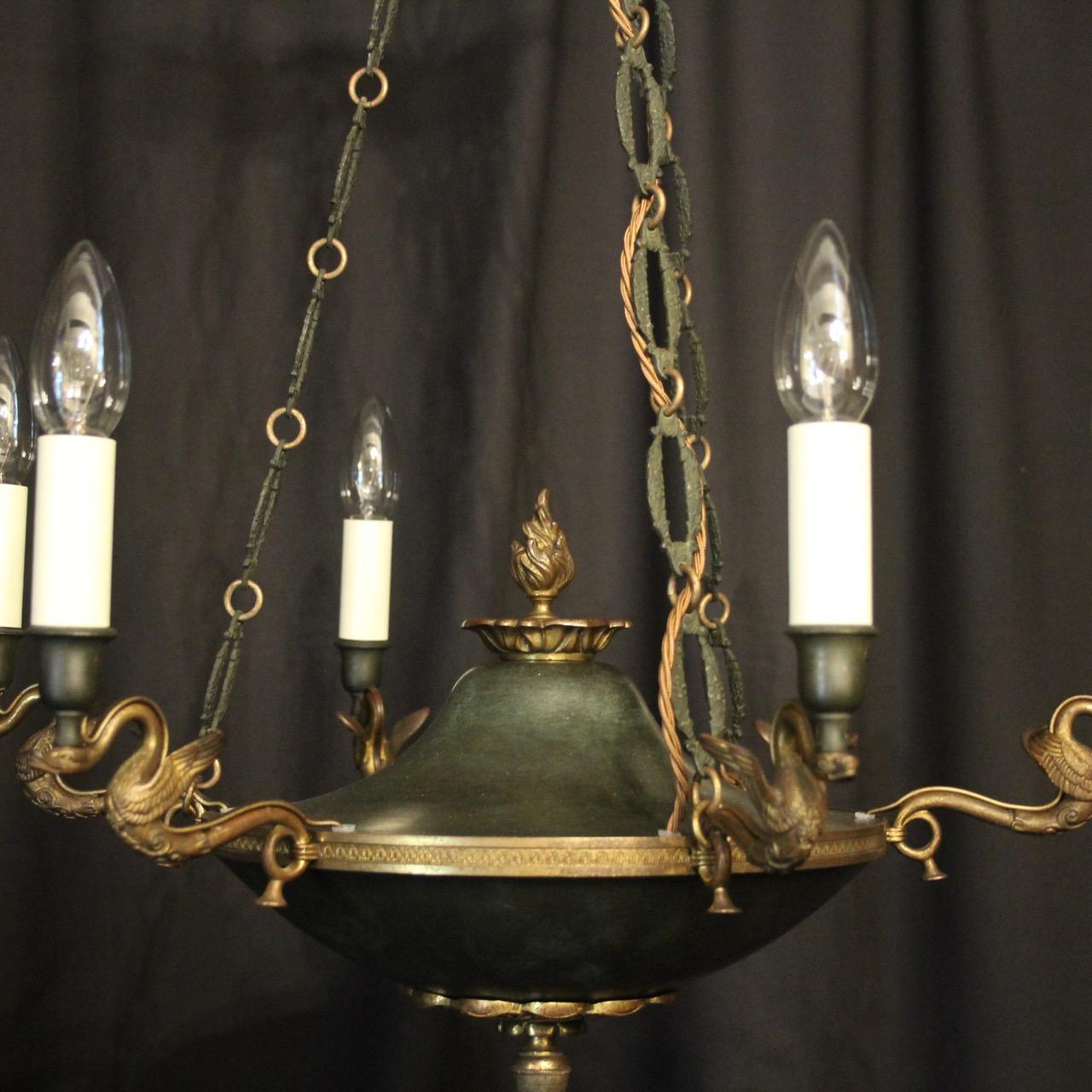 A French Empire gilded bronze and dark green enamelled 6-light antique chandelier, the decorative winged swan scrolling arms with bulbous enamelled candle sconces, issuing from an ornate Anthemion etched circular band with acorn base, flame centre