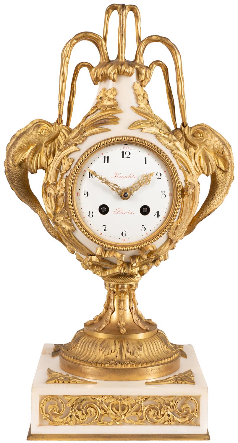 A very good quality French 19th century gilded Ormolu and Carrara marble mantel (fireplace) clock, having a Dolphin mounted on either side of the white enamel eight day clock, which strikes on the hour and half hour. Raised on a classical pedestal