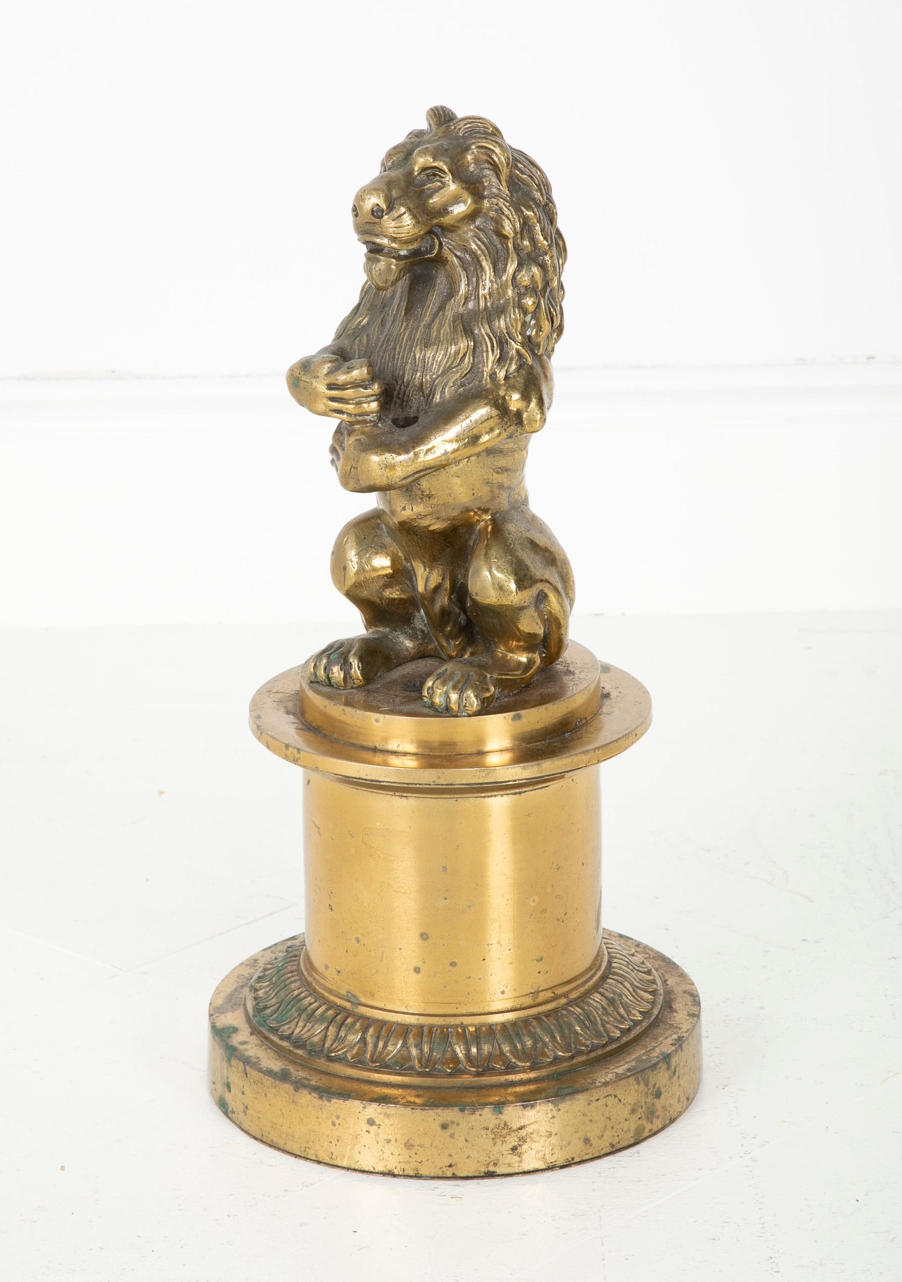The lion is seated on his haunches sitting on a raised circular plinth. He can hold a small flag or banner of your choice in his front paws. A very good bronze cast with a nice gilded surface. French, 19th century.
Measures: 15 inches high, 8.75