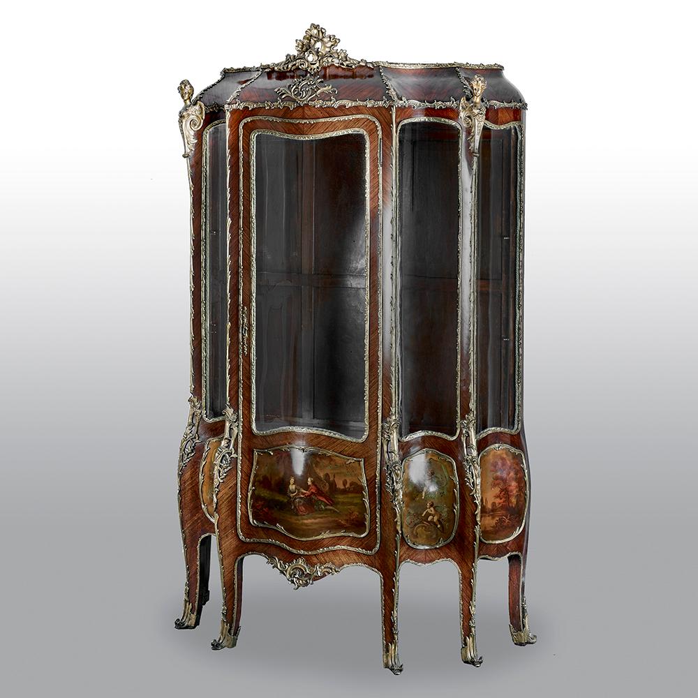 This fine and large Rococo style vitrine cabinet is crafted in kingwood, in a bombe form and features a large central panel flanked by four concave and convex panels. Below the glass there are five fine gilt-bronze-framed Vernis Martin panels.