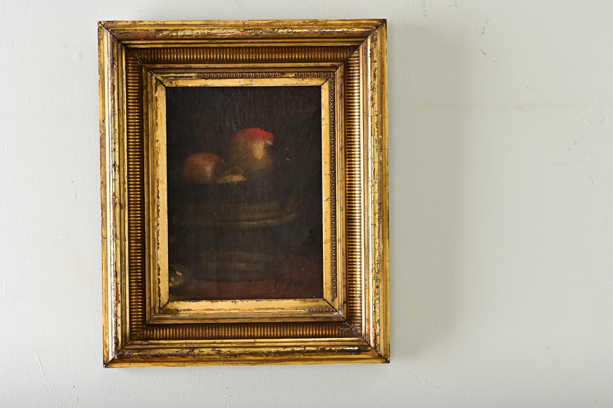 This mysterious little canvas from 19th century Paris depicts a still-life arrangement in monochromatic tones of brown and red, so deep in saturation that the forms of the bowl and fruit are indistinct below the crackled pigment. The gold gilt frame