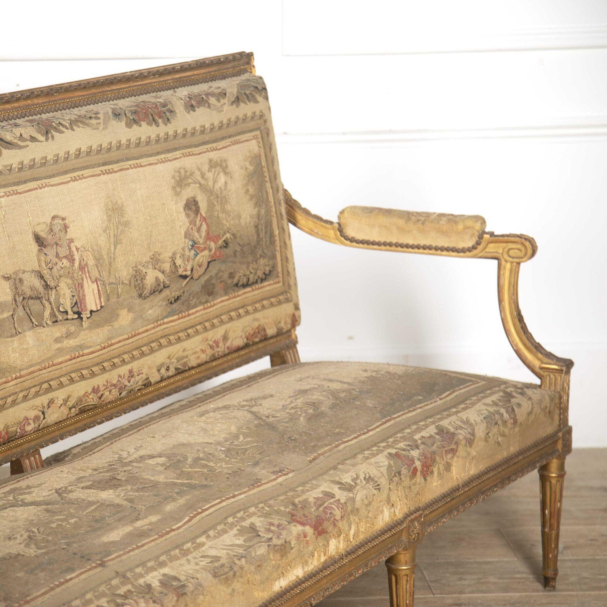 Large French 19th century sofa, circa 1880. 
This sofa has an elegant rectilinear form in the neoclassical style. The straight back and seat are softened by downswept armrests and uprights. 
The whole rests on eight reeded column tapering legs,