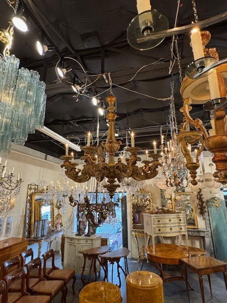 Gorgeous large scale 19th century French carved and parcel gilt wood chandelier. Circa 1880. The chandelier has been professionally rewired, comes with matching chain and canopy. It is ready to hang! 53h x 48w