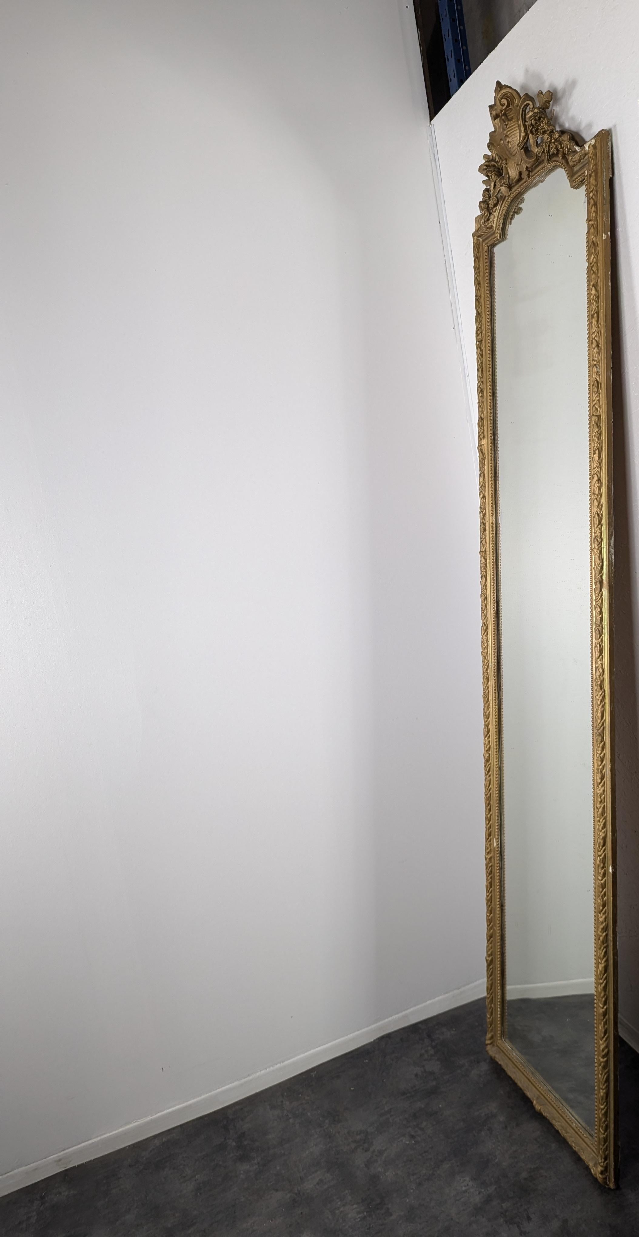 These French 19th-century Louis XVI pier mirrors, crafted from intricately carved giltwood, embody the elegance and symmetry characteristic of neoclassical design. Each mirror is framed with fine detailing, featuring iconic Louis XVI motifs such as