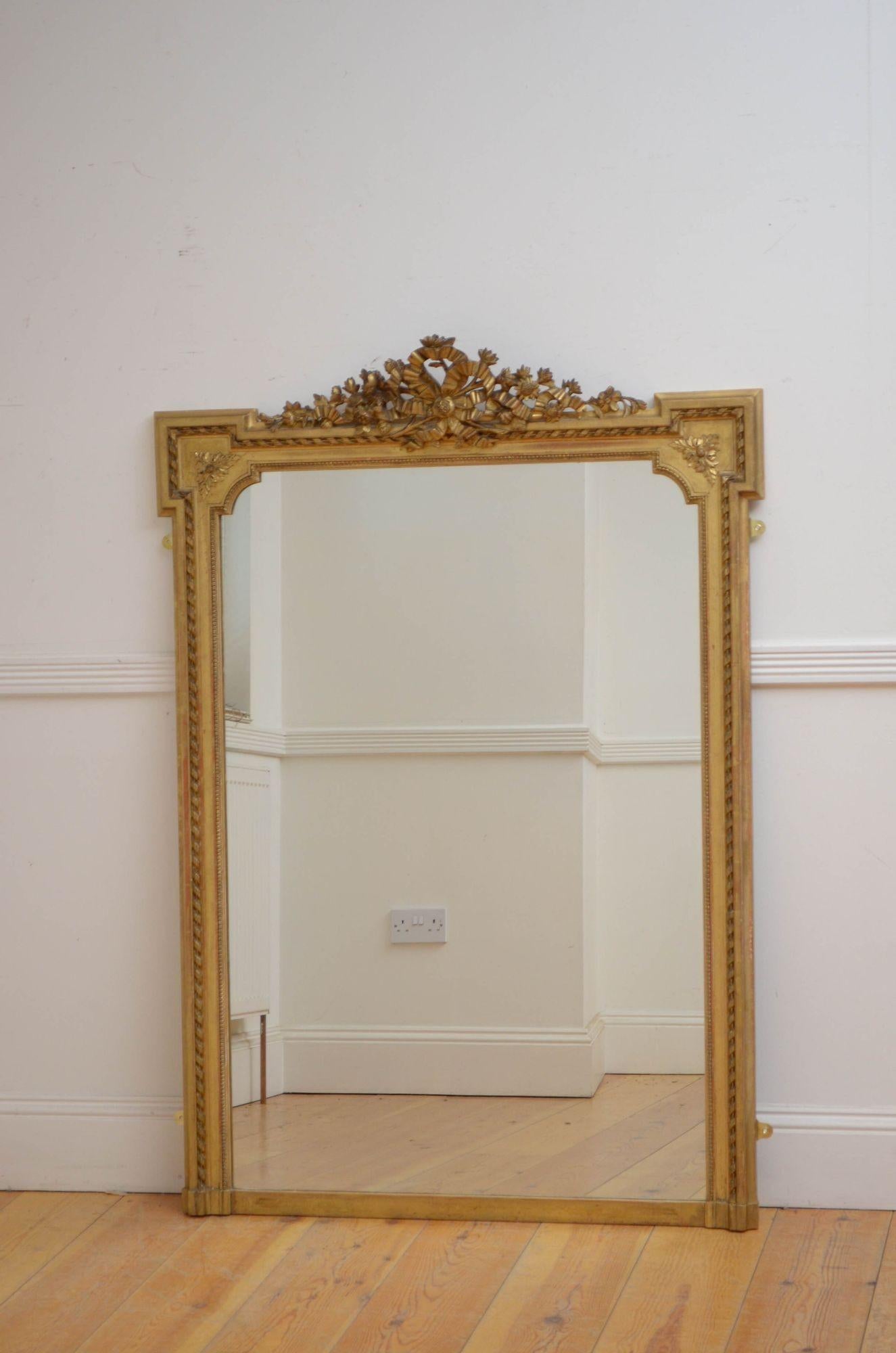 Sn5390 fine 19th century French gilded wall mirror, having original glass with some imperfections in moulded, carved and gilded frame with foliage centre crest decorated with a bow. This antique mirror retains its original glass, original gilt and
