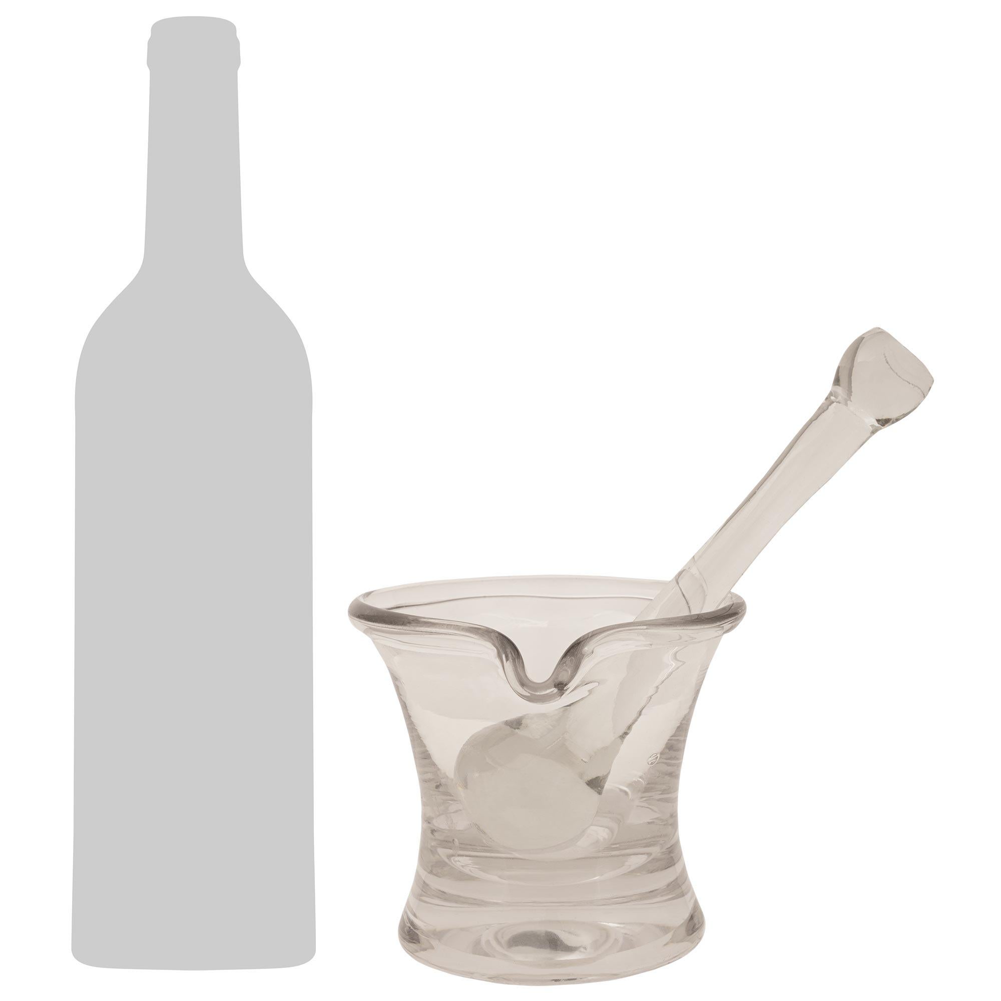 Un élégant et charmant mortier et pilon en verre du XIXe siècle. Ce mortier en verre transparent merveilleusement utilitaire présente une forme voluptueuse et raffinée avec le corps effilé du mortier menant au bec courbé en forme de main. Le pilon