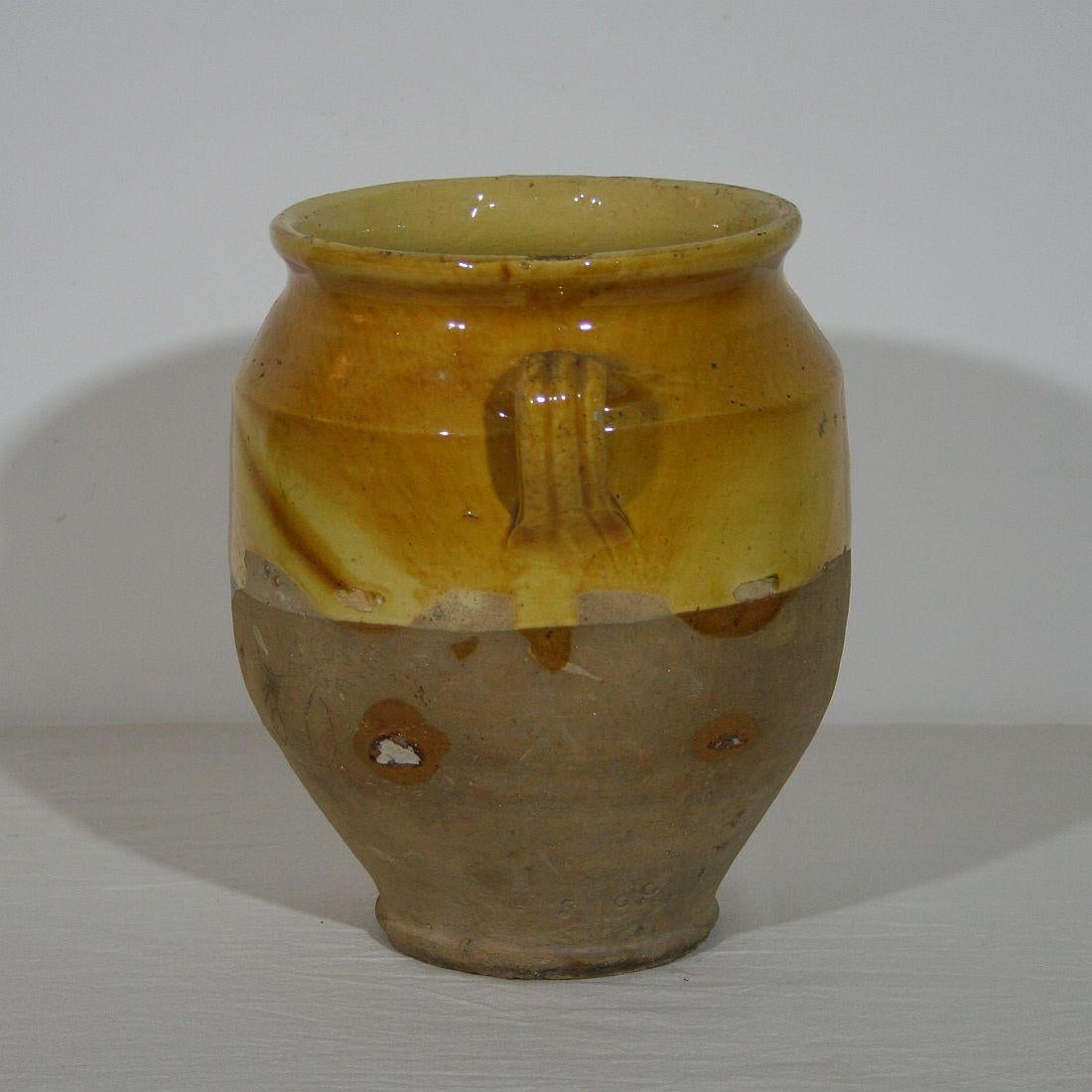 Beautiful weathered confit jar. Confit jars were used primarily in the South of France for the preservation of meats such as duck or goose for dishes such as cassoulet or foie gras. The bottom halves were left unglazed, due to the fact that the pots