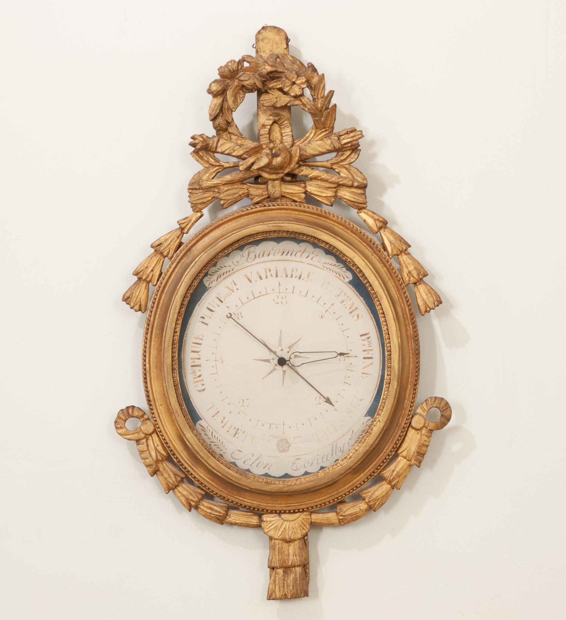 A fabulous French gold-gilt barometer from the beginning of the 19th century. This early instrument of meteorology has been adorned with an extraordinary wreath crest with carved laurel leaves, a plane, saw, and measuring sticks. The face has hand