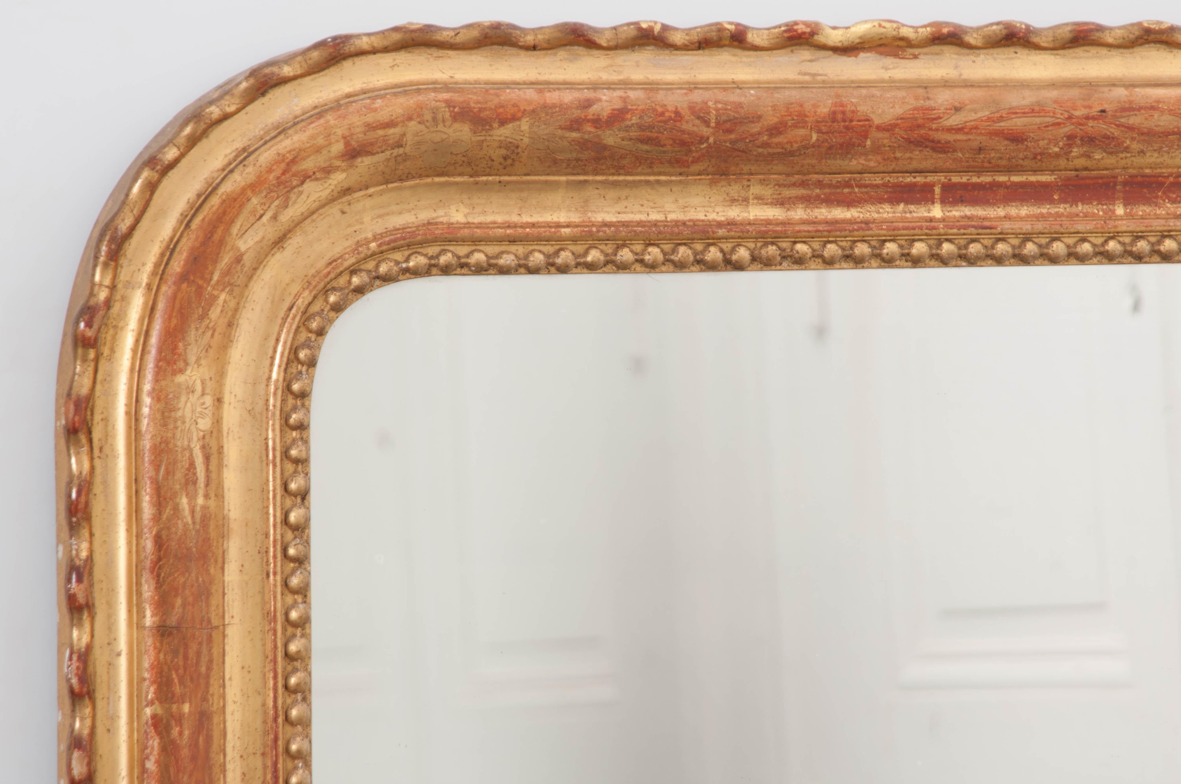 This fantastic gold gilt Louis Philippe mirror was made in France, circa 1880. The classic design of the Louis Philippe mirror is universally loved for its versatility and simple brilliance. This Louie’s frame has a wavy design on its outer