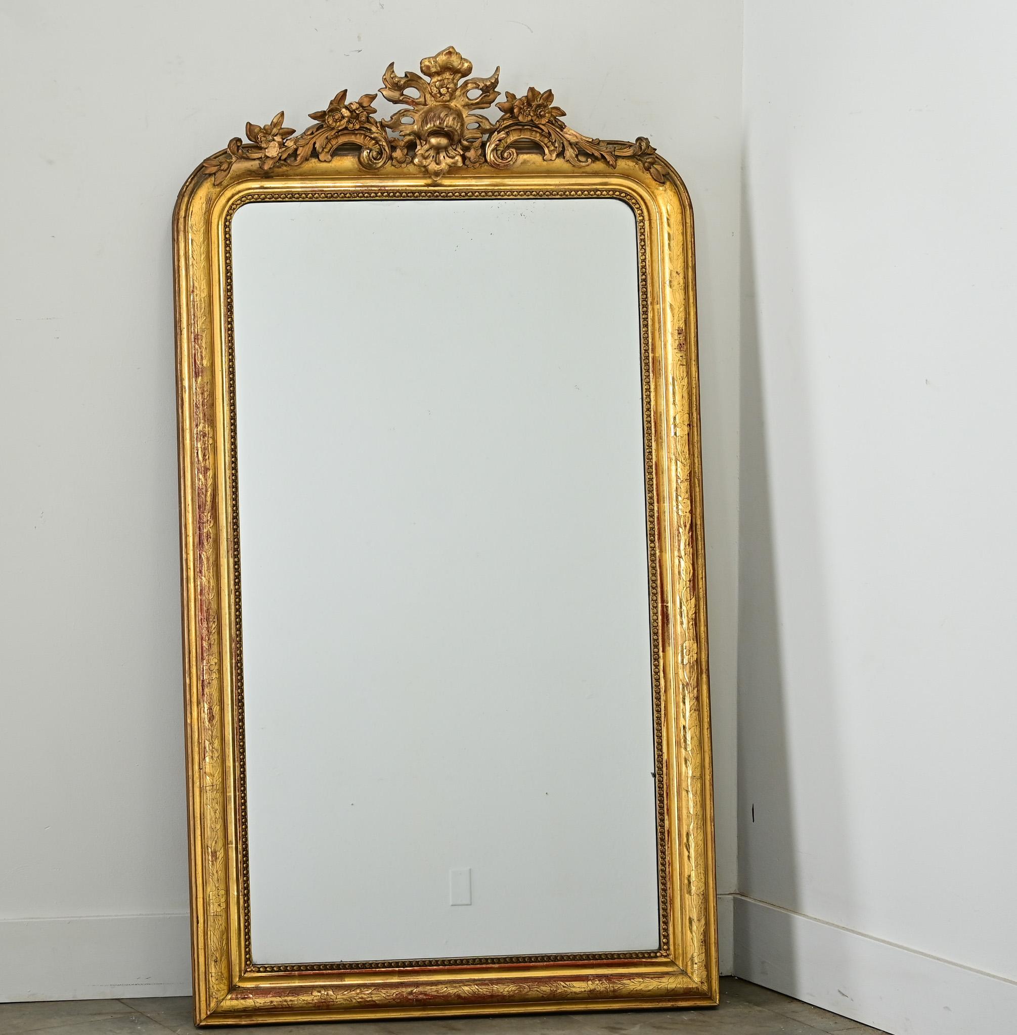 Un impressionnant miroir Louis Philippe doré à l'or fin avec les coins arqués caractéristiques en haut, surmontés d'une 