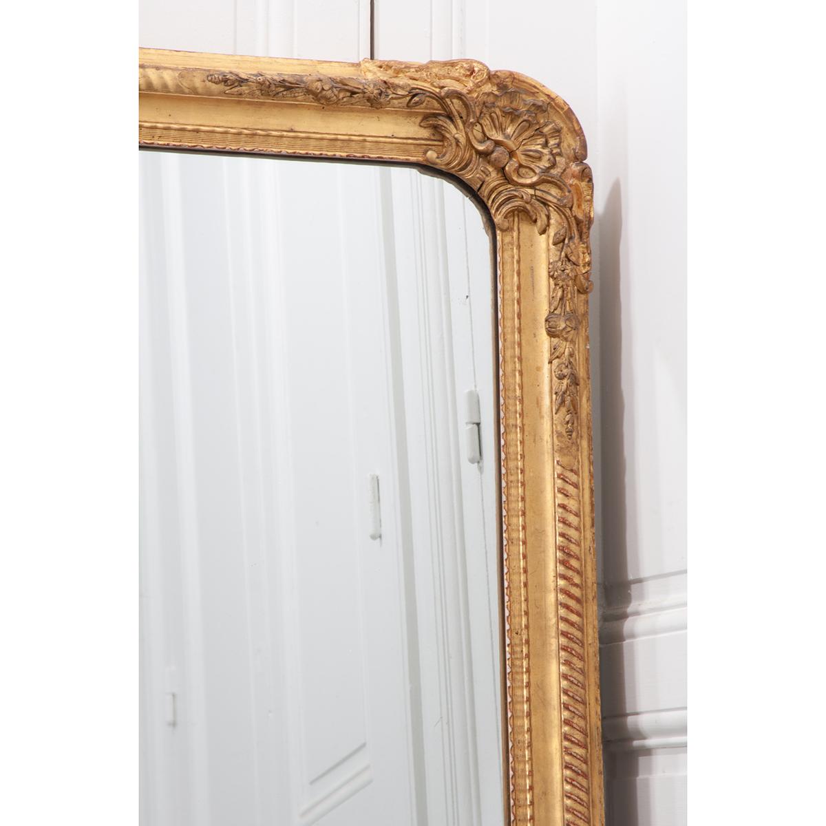 This is a 19th century gold gilt mirror from France. It has its original mirror plate with some aging and lots of sparkles. We wish you could see the beauty of this mirror plate in the photos, it is spectacular! The frame has shells and foliate